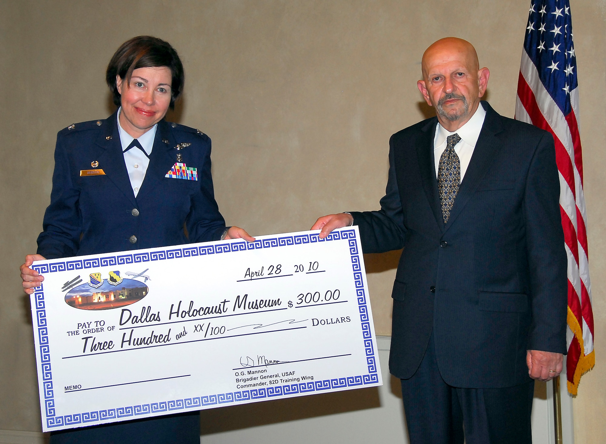 Team Sheppard donates $300 to the Dallas Holocaust Museum at the Holocaust Remembrance Service at the North Chapel April 29, 2010. Col. Lista Benson, 882nd Training Group commander, presented the donation check to Paul Kessler the guest speaker for the event. Mr. Kessler spoke about the significance of upstanders during the Holocaust. (U.S. Air Force Photo/Harry Tonemah)