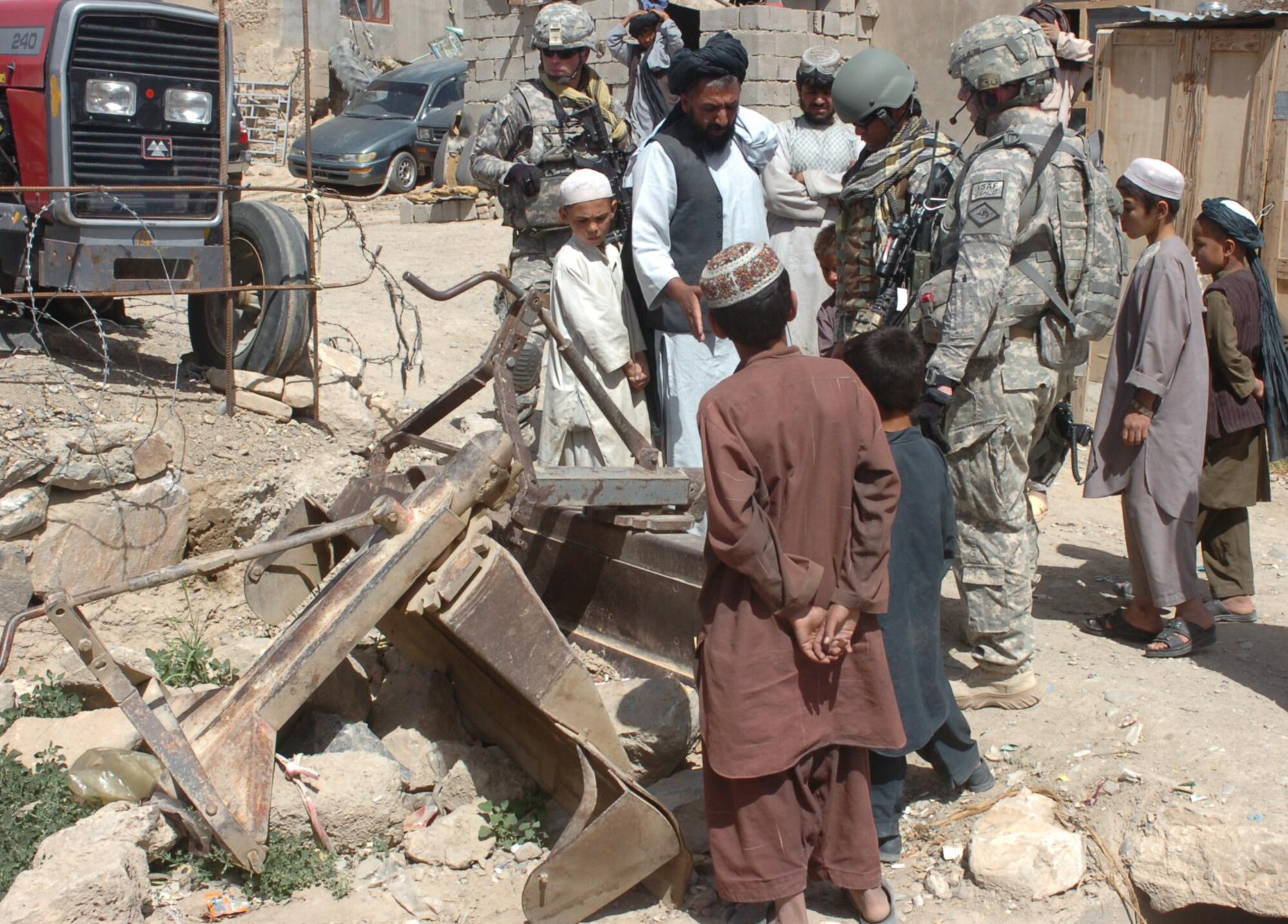 Sgt. Eric Holcomb, 1st Lt. Addison Taylor and their interpreter discuss farming equipment with a dealer at the Qalat City Bazaar on April 29, 2010. The Soldiers, members of the Arkansas Agriculture Development Team in Zabul, visited the bazaar to locate stores that supply farming materials and equipment in order to establish a supply chain to support the team's agricultural education and training programs throughout the province. The ADT is comprised of Soldiers from the Arkansas National Guard and Airmen from the 188th Fighter Wing and bring with them expertise in a wide array of farming, agriculture and irrigation specialties. (U.S. Air Force photo by Lt. Col. Keith Moore/Arkansas National Guard Public Affairs)

