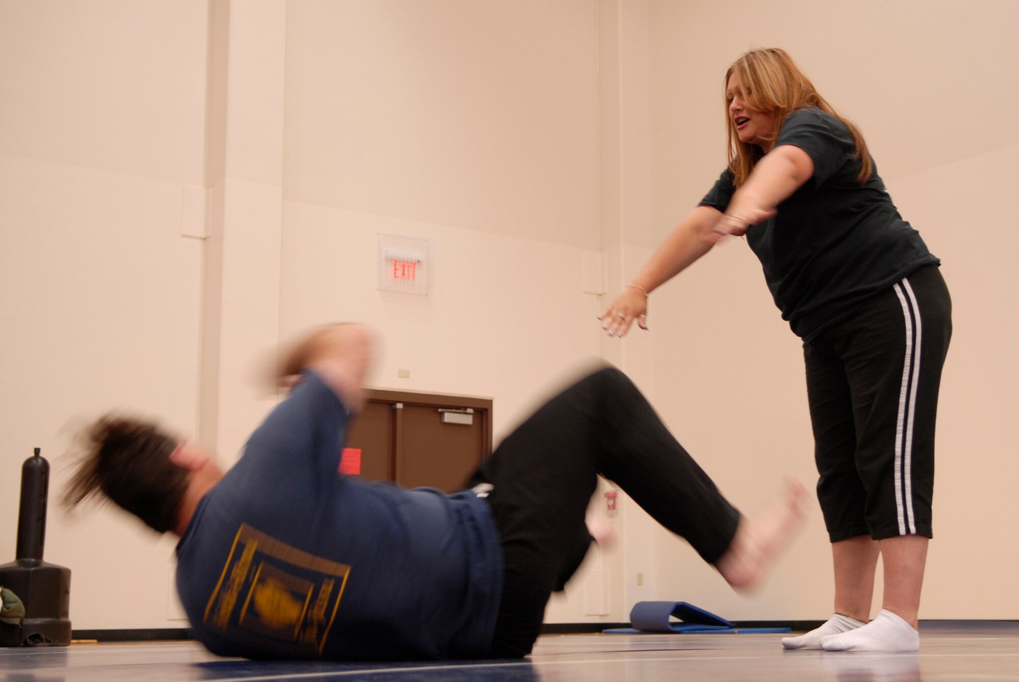 VANDENBERG AIR FORCE BASE, Calif. -- Ms. Guille Macias pushes Mr. Randy Ancheta, a third degree Jiu-Jitsu black belt sensei, after getting out of a bear hug during a self defense workshop at the base fitness center here Wednesday, April 28, 2010.  The participants in the workshop learned how to properly defend themselves from assailants.  (U.S. Air Force photo/Senior Airman Andrew Satran) 

 

 

 

 

 

 