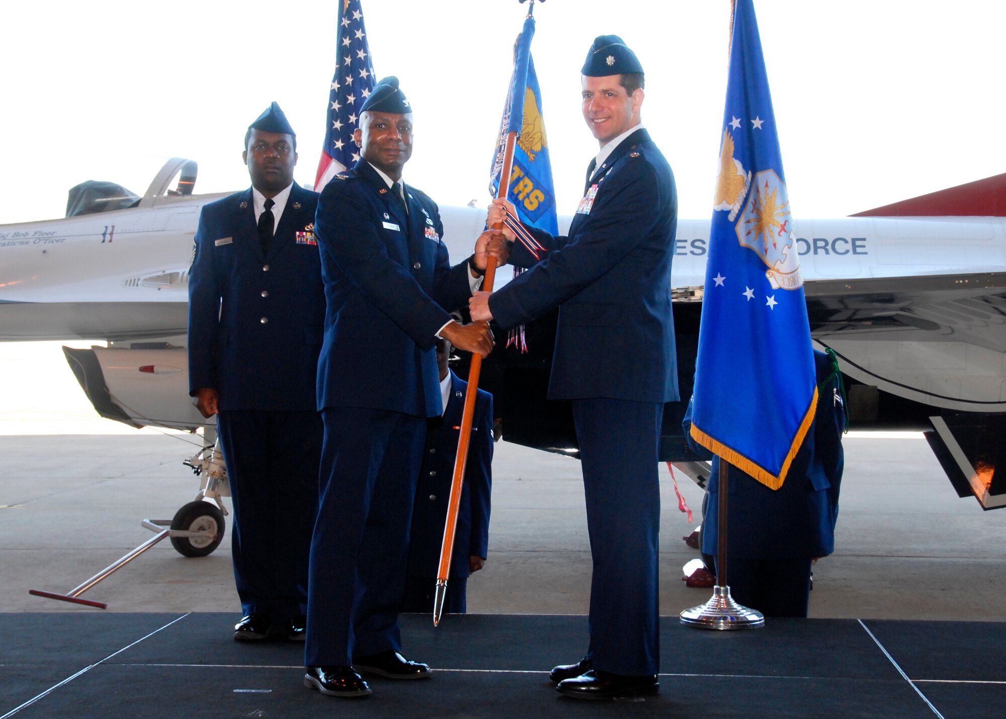 During the 364th Training Squadron assumption of command ceremony, Col. Tony Pounds, 782nd Training Group commander, passes the guidon to Lt. Col. John Fraser, the incoming squadron commander, April 29, 2010. Colonel Fraser was last assigned to the United States European Command Headquarters as the communications plan officer.   (U.S. Air Force photo/Mike Litteken)