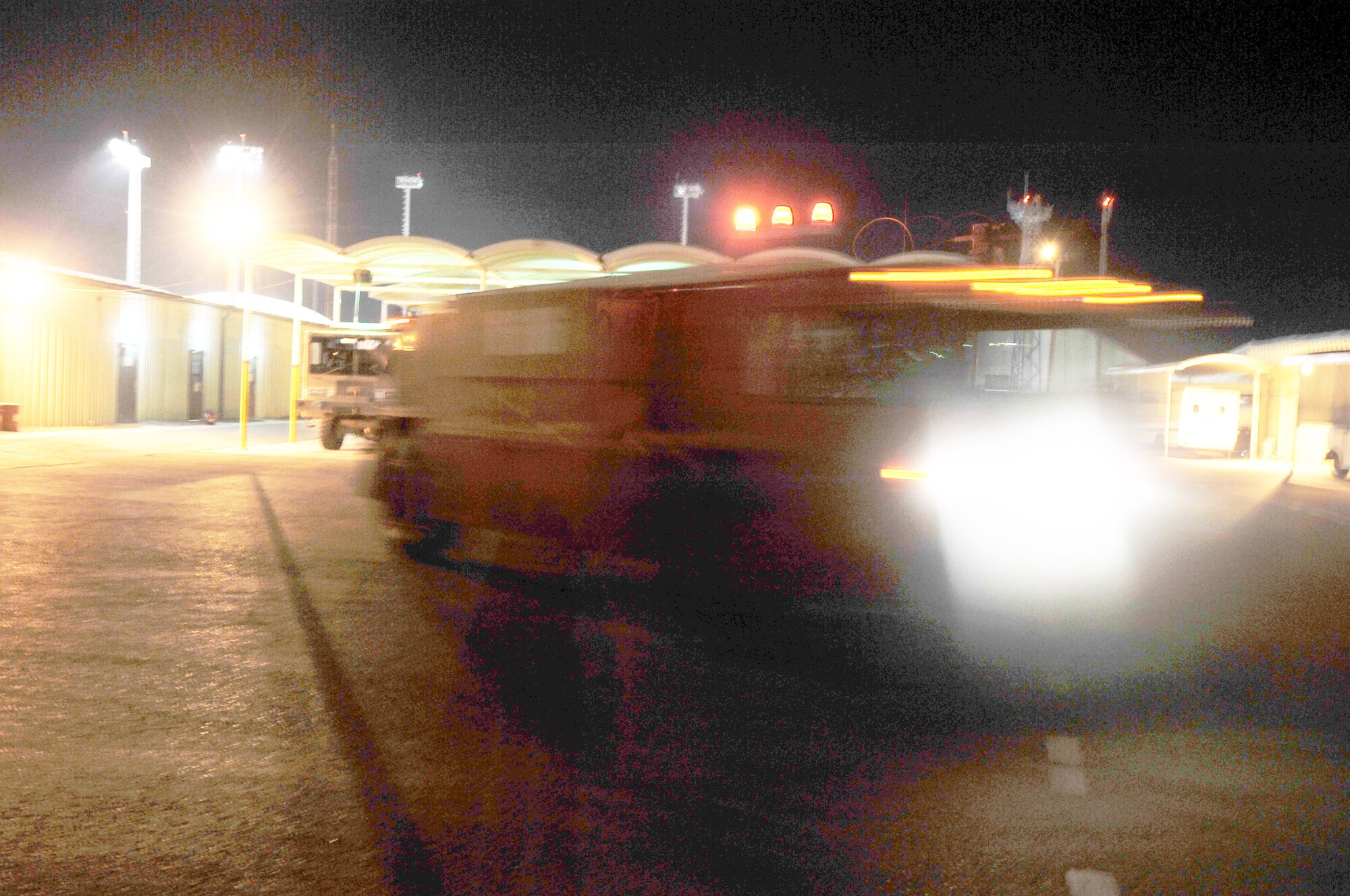 A crew of firefighters from the 380th Expeditionary Civil Engineer Squadron respond to an emergency in their truck during night operations April 30, 2010, at a non-disclosed base in Southwest Asia. The 380th ECES, as part of the 380th Air Expeditionary Wing, supports operations Iraqi Freedom and Enduring Freedom and the Combined Joint Task Force-Horn of Africa. (U.S. Air Force Photo/Master Sgt. Scott T. Sturkol/Released)