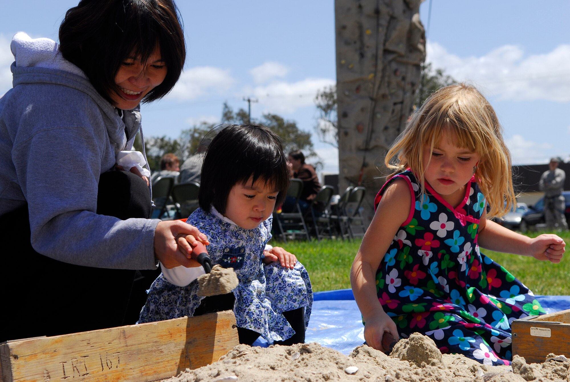 VANDENBERG AIR FORCE BASE, Calif. -- Excavating the dirt, Anna Vuong and her daughter Brianna, and Emma McManus, search for shells and stones during Vandenberg's 10th Annual Earth Day event in front of the base library here Wednesday, April 29, 2010.  Base archeologists have excavated sites on base that are approximately 10,600 years old.  (U.S. Air Force photo/Senior Airman Andrew Satran) 

 