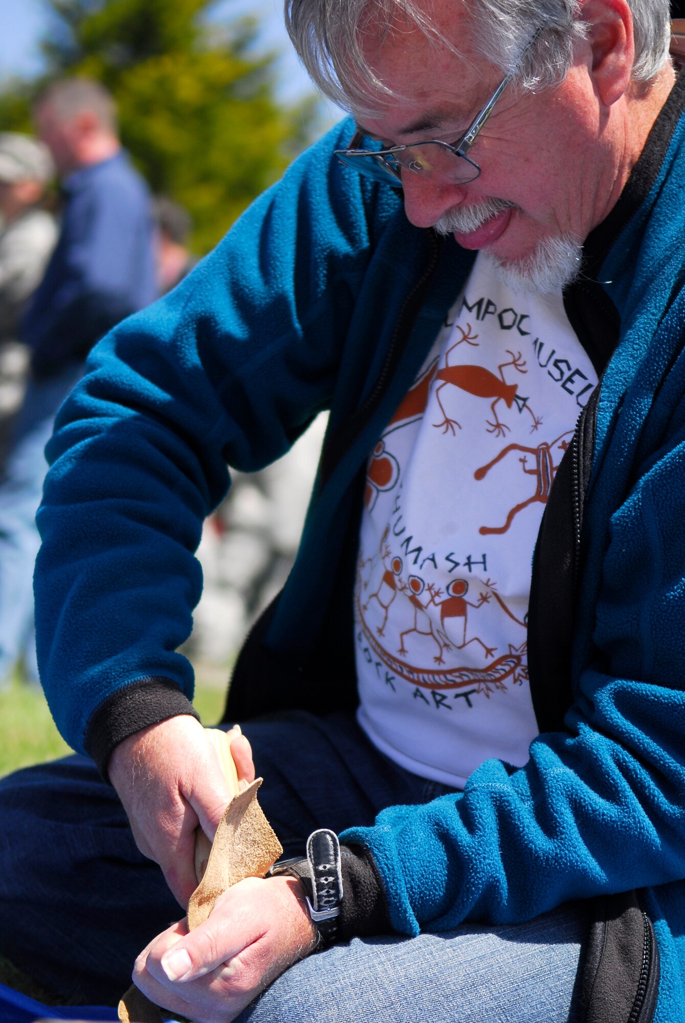 VANDENBERG AIR FORCE BASE, Calif. -- Pressure flaking a stone, Bob Peterson, a 30th Civil Engineer Squadron archeologist,  carves out a tool with a copper pressure flaker during Vandenberg's 10th Annual Earth Day event in front of the base library here Wednesday, April 29, 2010.  Pressure flaking is a technique used to carve stones into hand-made weapons and tools.  (U.S. Air Force photo/Senior Airman Andrew Satran) 

 
 

 

 

 

 