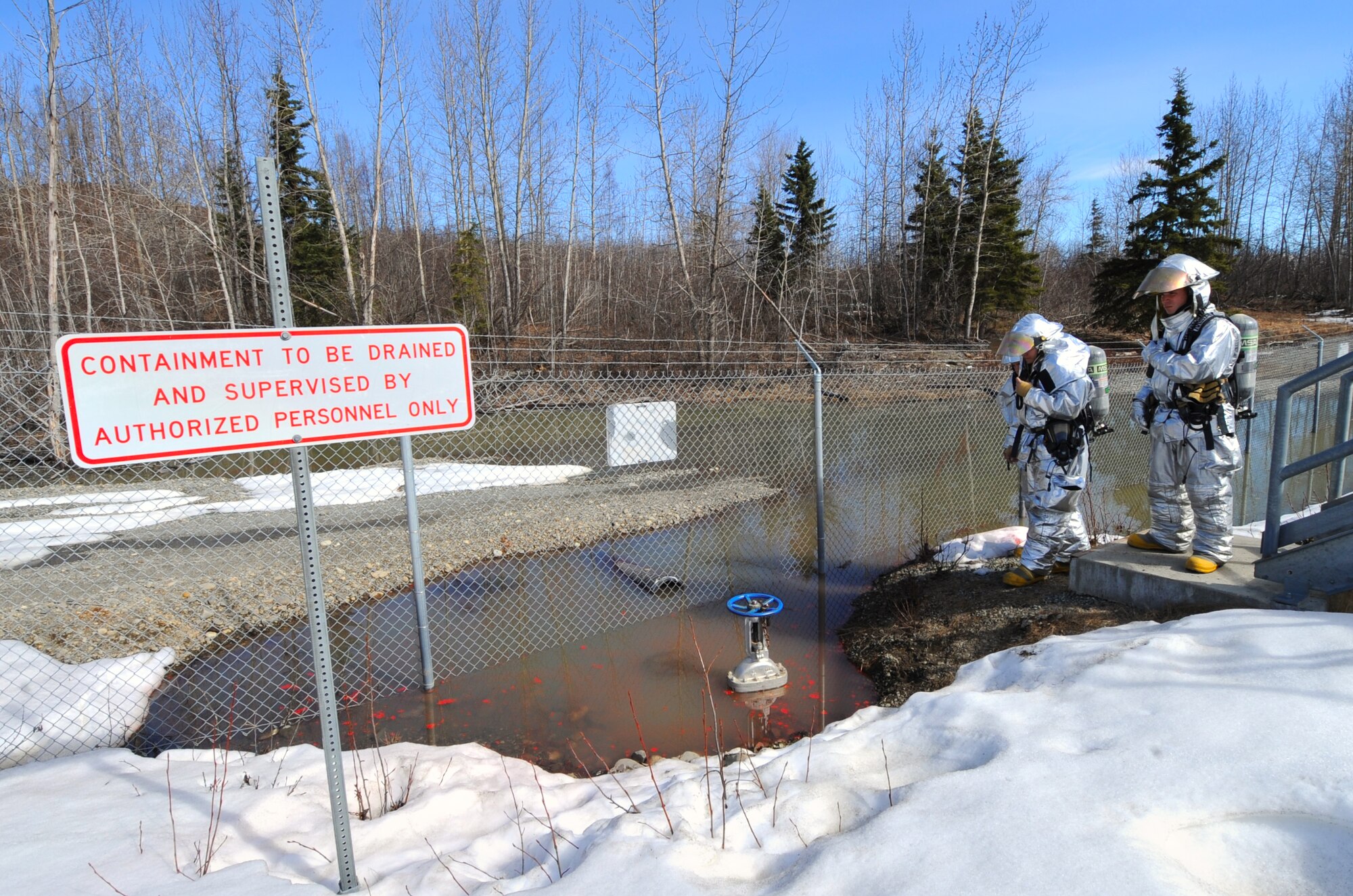 ELMENDORF AIR FORCE BASE, Alaska – Firefighters with the 3rd Civil Engineer Squadron assess the damage from a simulated oil spill as part of the Arctic Edge 10 exercise here April 27. Arctic Edge 10 is a major exercise conducted in cooperation with the State of Alaska Division of Homeland Security and Emergency Management and other federal, state and local agencies. (Air Force photo by Senior Airman Cynthia Spalding)