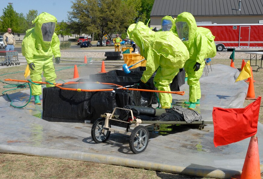 GOODFELLOW AIR FORCE BASE, Texas – Firefighters from the 17th Civil Engineer Squadron decontaminate a simulated victim during exercise Scarlet Hawk 09-06, March 31, 2009 at Goodfellow Air Force Base, Texas. Training exercises are conducted quarterly to maintain base disaster and emergency readiness. The 17th Training Wing trains intelligence officer and enlisted members in the intelligence field including imagery analysis, communications signals intelligence production, cryptologic linguists, network intelligence analysis, electronics signal intelligence exploitation, electronic systems security assessment and airborne cryptologic linguists. The 17th Training Wing is also responsible for training firefighters from all branches of the service. The wing also has units at the Defense Language Institute in Monterey, Calif.; Corry Station in Pensacola, Fla.; and Fort Huachuca, Ariz. (U.S. Air Force photo/Lou Czarnecki)