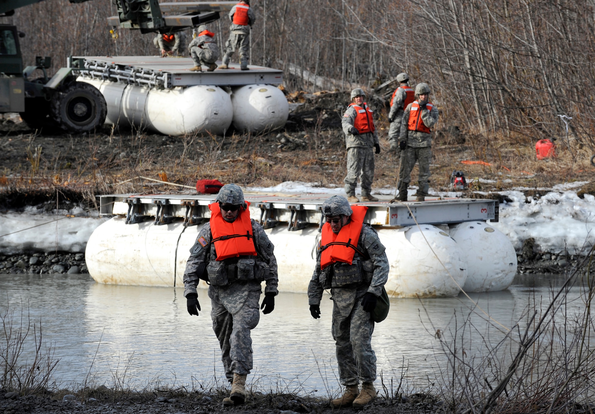 Soldiers from the 84th Engineer Support Company, 6th Engineer Battalion, construct a Lightweight Modular Causeway System during testing at Fort Richardson, Alaska, April 28. The LMCS is a hybrid fixed bridging system and floating causeway system.  Originally designed for vessel-to-shore bridging applications, it has proven ideally suited for wet-gap crossing solutions.  The load capacity is 70 tons. Here it is being used to respond during Arctic Edge 2010 as an earthquake recovery tool. (U.S. Air Force photo/Staff Sgt. Brian Ferguson)