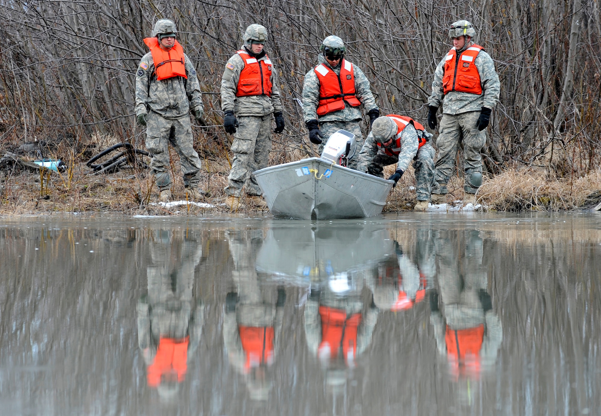 Soldiers from the 84th Engineer Support Company, 6th Engineer Battalion, prepare a safety boat before the construction and testing of a Lightweight Modular Causeway System at Fort Richardson, Alaska, April 28. The LMCS is a hybrid fixed bridging system and floating causeway system.  Originally designed for vessel-to-shore bridging applications, it has proven ideally suited for wet-gap crossing solutions.  The load capacity is 70 tons. Here it is being used to respond during Arctic Edge 2010 as an earthquake recovery tool. (U.S. Air Force photo/Staff Sgt. Brian Ferguson)