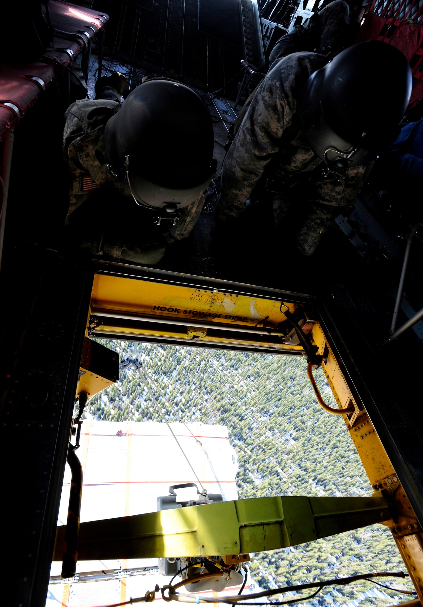 CH-47 Chinook aircrew members check the status of a piece of Lightweight Modular Causeway System as it is flown over Fort Richardson, Alaska, during testing April 27. The LMCS is a hybrid fixed bridging system and floating causeway system.  Originally designed for vessel-to-shore bridging applications, it has proven ideally suited for wet-gap crossing solutions.  The load capacity is 70 tons. Here it is being used to respond during Arctic Edge 2010 as an earthquake recovery tool. (U.S. Air Force photo/Staff Sgt. Brian Ferguson)
