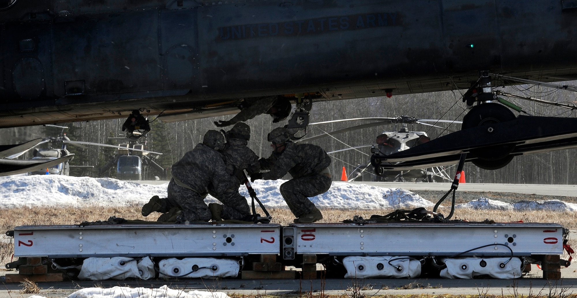 Soldiers from the 84th Engineer Support Company,6th Engineer Battalion, sling-load a section of Lightweight Modular Causeway System to a CH-47 Chinook during testing at Fort Richardson, Alaska, April 27. The LMCS is a hybrid fixed bridging system and floating causeway system.  Originally designed for vessel-to-shore bridging applications, it has proven ideally suited for wet-gap crossing solutions.  The load capacity is 70 tons. Here it is being used to respond during Arctic Edge 2010 as an earthquake recovery tool. (U.S. Air Force photo/Staff Sgt. Brian Ferguson)