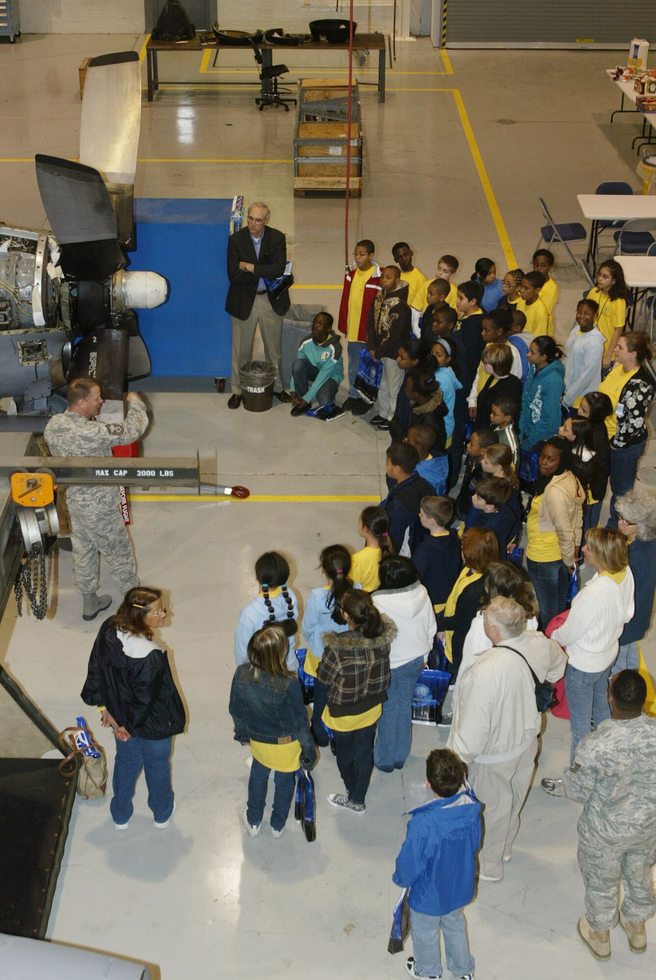 Senior Master Sgt. Phil LaRue, 94th Maintenance Squadron propulsion flight chief, leads a group of 40 students from Russell Elementary School Space Team program on a tour of the propulsion section at Dobbins Air Reserve Base March 12.  (U.S. Air Force photo/Don Peek)