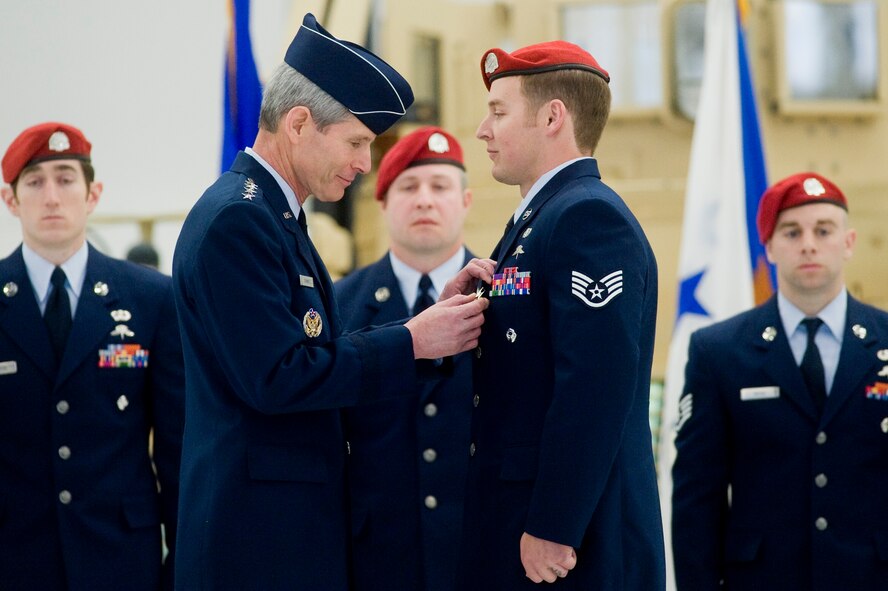 Chief of Staff of the Air Force Gen. Norton A. Schwartz pins the Silver Star on Staff Sgt. Sean Harvell during a medal ceremony at Joint Base Lewis-McChord, Wash., April 29.  Two Silver Stars, the nation's third highest decoration for valor, were presented first to Sergeant Harvell for his actions during multiple firefights with enemy forces in Afghanistan during spring and summer 2007.  (U.S. Air Force photo/Abner Guzman)
