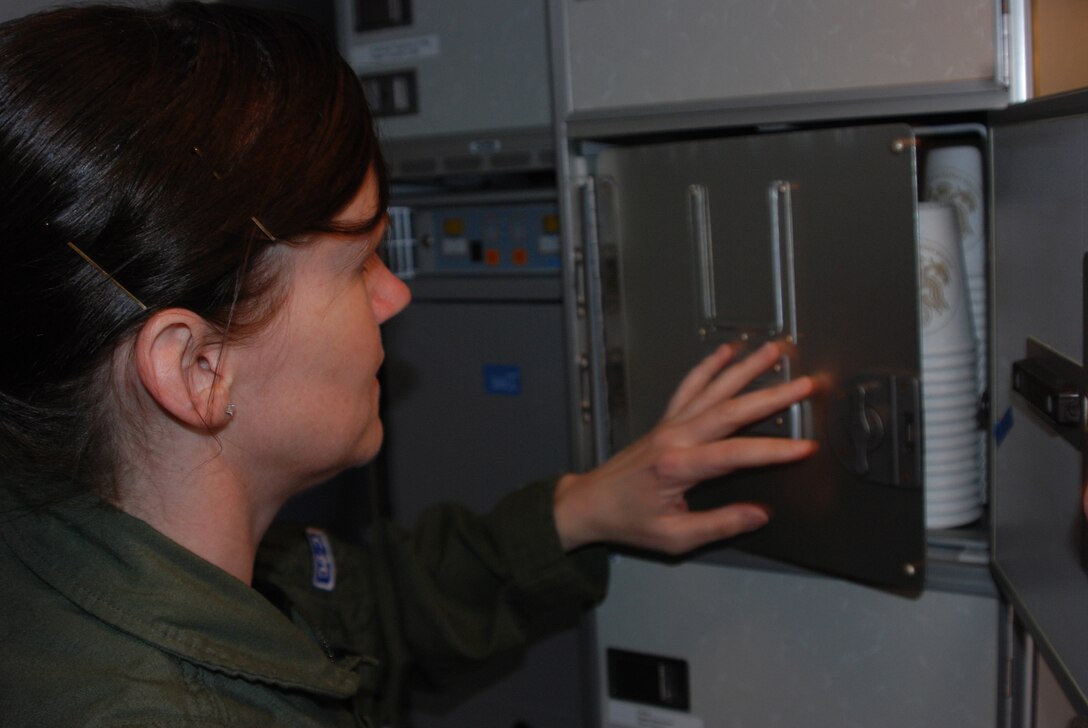 Tech. Sgt. April Tarbill, 73rd Airlift Squadron flight attendant, prepares a C-40C cabin for departure. Distinguished Visitor airlift is a unique mission in the Air Force Reserve.  (U.S. Air Force photo/Tech. Sgt. Christian Michael) 