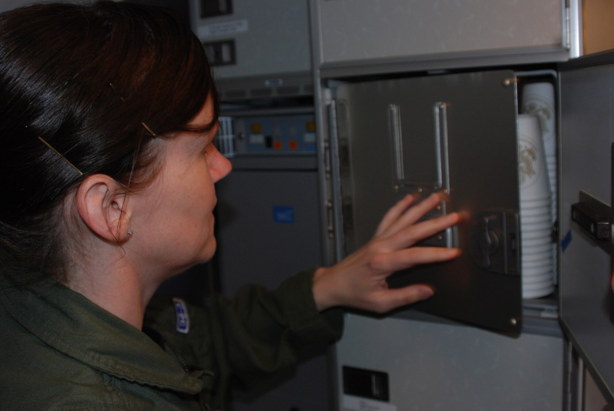Tech. Sgt. April Tarbill, 73rd Airlift Squadron flight attendant, prepares a C-40C cabin for departure. Distinguished Visitor airlift is a unique mission in the Air Force Reserve.  (U.S. Air Force photo/Tech. Sgt. Christian Michael) 