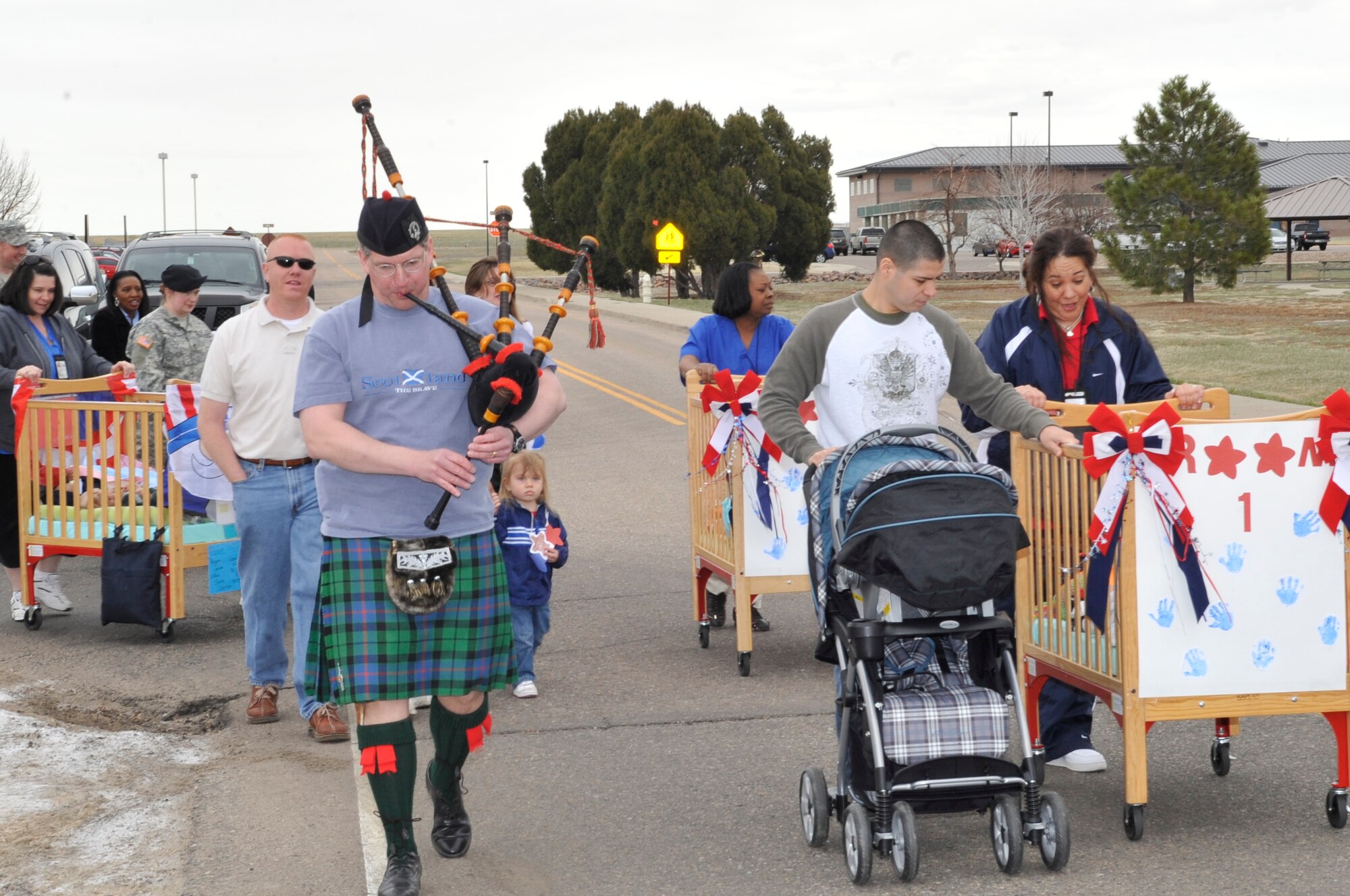 BUCKLEY AIR FORCE BASE, Colo. -- Lt. Col. William Morrison, 460th Mission Support Group deputy commander, leads the Month of the Military Child parade at the Crested Butte Child Development Center while playing the bagpipes. Both the A-Basin and Crested Butte CDCs held parades March 31. (U.S. photo by Airman 1st Class Paul Labbe)