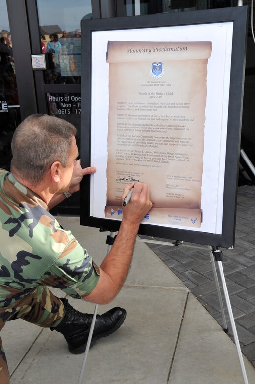 BUCKLEY AIR FORCE BASE, Colo. -- Col. Trent Pickering, 460th Space Wing vice commander, signs the Month of the Military Child Proclamation during the kick-off ceremony March 31. (U.S. photo by Airman 1st Class Paul Labbe)