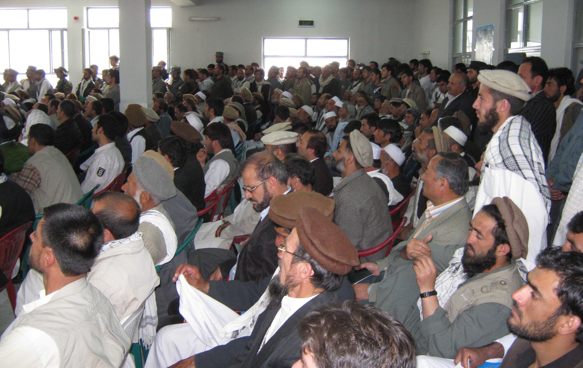 Hundreds of Afghans packed the standing-room-only auditorium at the Panjshir Provincial Afghan National Police Headquarters, Afghanistan, April 26 for a governor transfer-of-authority ceremony. Keramuddin Keram officially became the provincial governor, filling a seat that has been empty since late March. (Photo by U.S. Air Force 2nd Lt. Jason Smith, Provincial Reconstruction Team Panjshir)