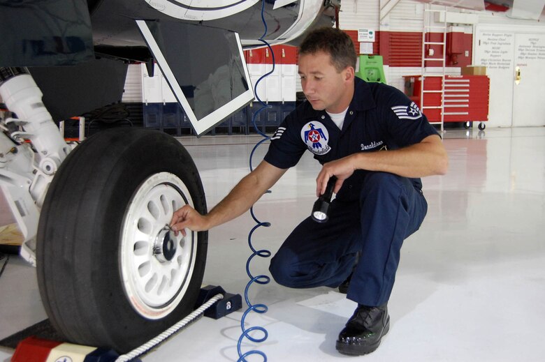 Staff Sergeant Donaldson inspects the wheel and tire assembly on an F-16. (U.S. Air Force Reserve photo/Capt. Jessica Martin)