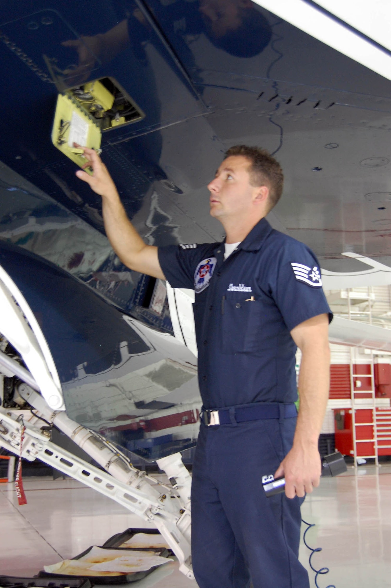 Staff Sergeant Donaldson inspects the hydraulic accumulator servicing on an F-16. (U.S. Air Force Reserve photo/Capt. Jessica Martin)