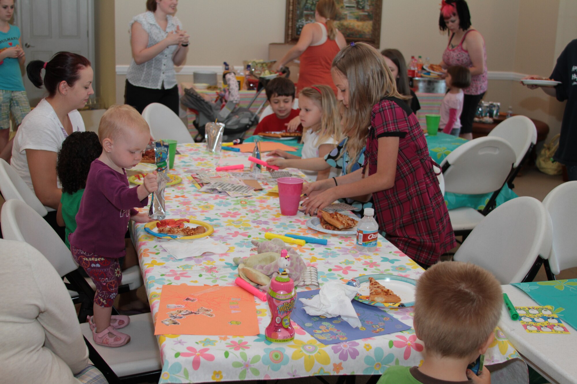 Families of deployed members eat dinner April 29 at a pizza party for base housing residents hosted by Hunt Pinnacle. The pizza party was an opportunity for families to socialize with one another and make crafts (U.S. Air Force photo by Airman 1st Class Rochelle Clace)
