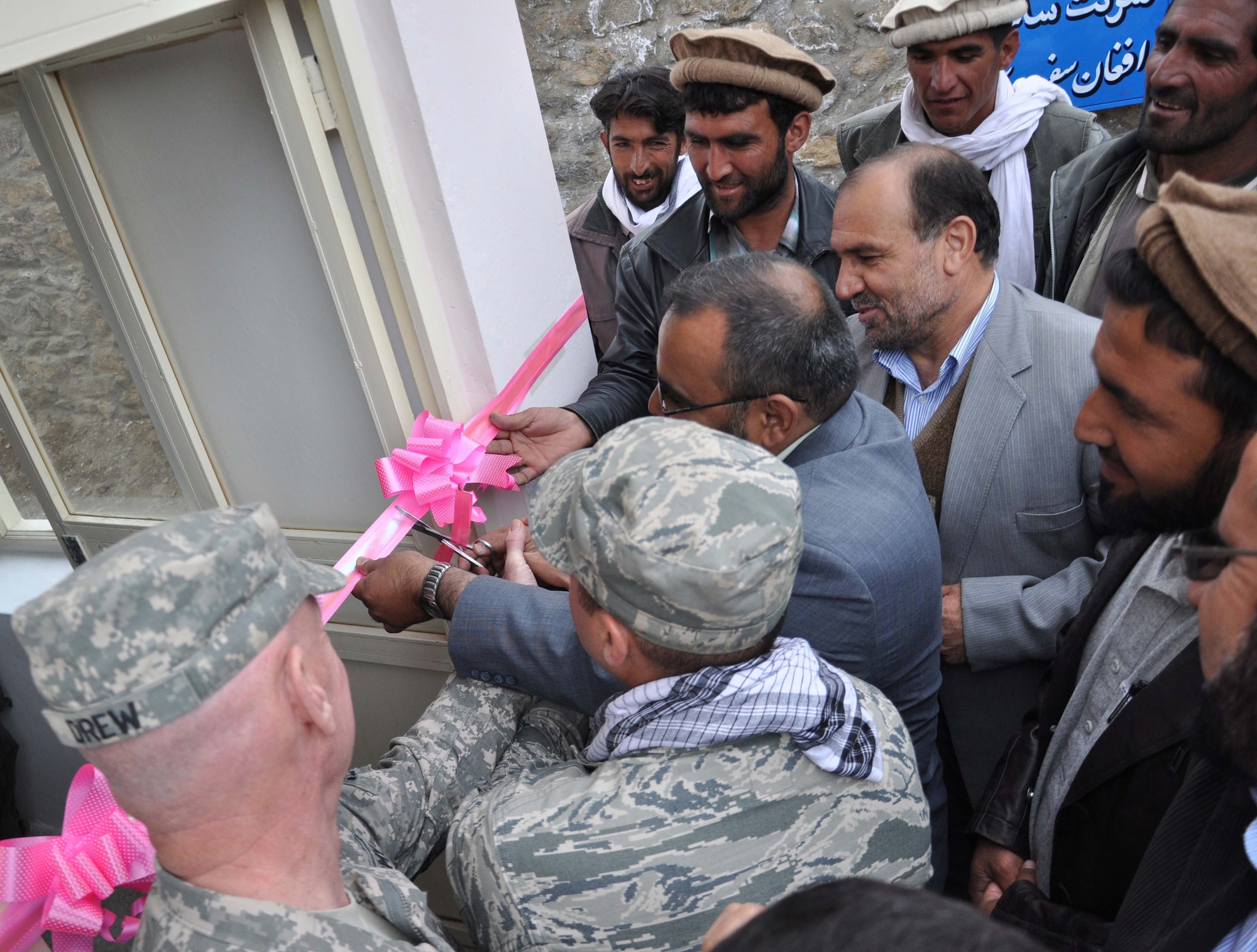 Panjshir Province Acting Governor Abdul Rahman Kabiri (with scissors), along with U.S. Army Col. Thomas Drew (far left), Task Force Wolverine deputy commander, and U.S. Air Force Lt. Col. Curtis Velasquez (center), Provincial Reconstruction Team Panjshir commander, cut the ribbon on a new Maternal Health Center in the far north area of the Panjshir Province, Afghanistan, April 7. (U.S. Air Force photo by Capt. Phillip Baker, PRT Panjshir Civil Engineer)