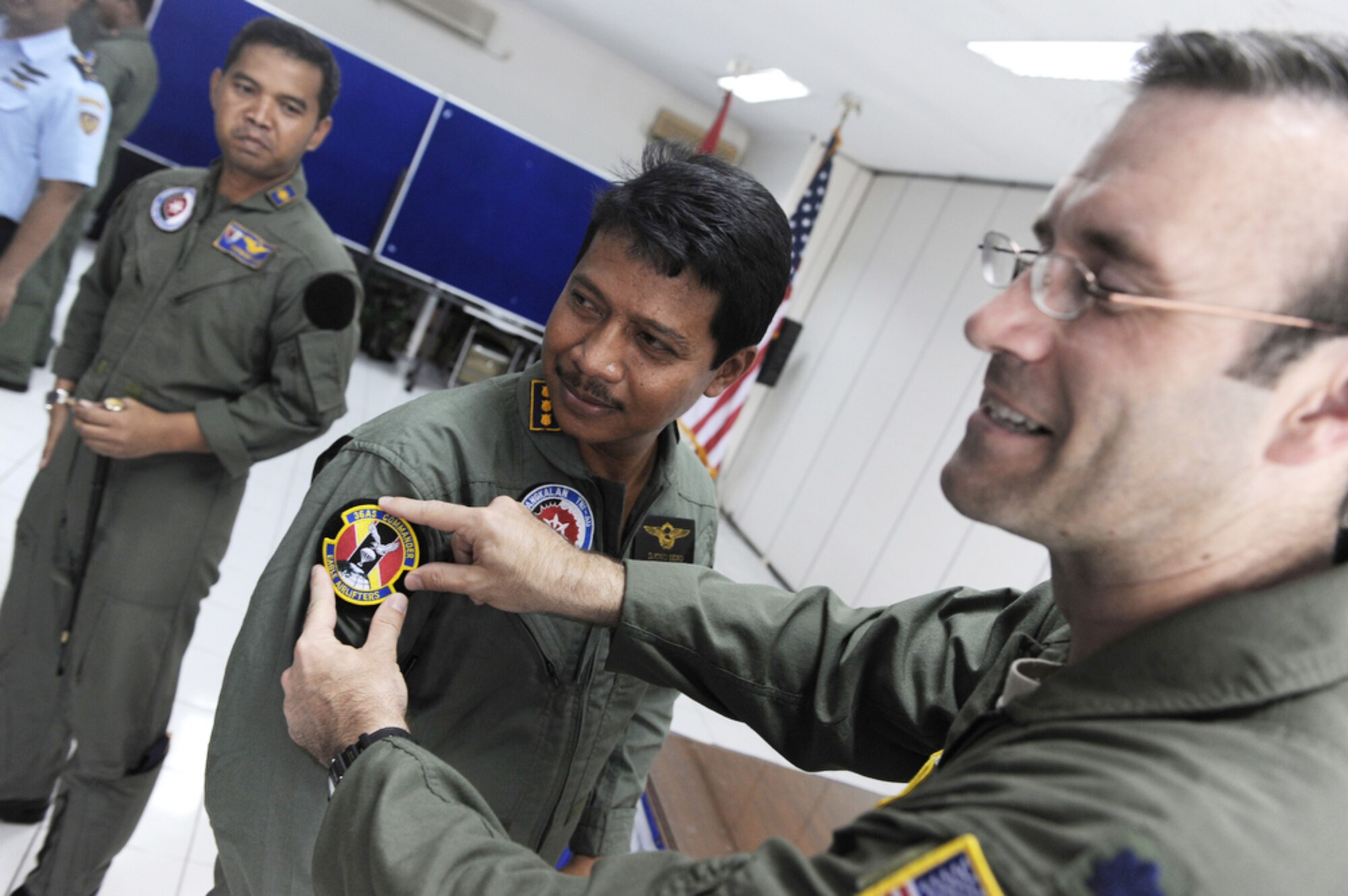 Indonesian air force Col. Djoko Senoputro (center) exchanges squadron patches with Lt. Col Dave Kincaid at the closing ceremony of Exercise Cope West 10 April 23, 2010, at Halim Air Base, Indonesia. Colonel Senoputro is the Halim AB commander. Colonel Kincaid is the 36th Airlift Squadron commander. (U.S. Air Force photo/Tech. Sgt. Cohen A. Young)