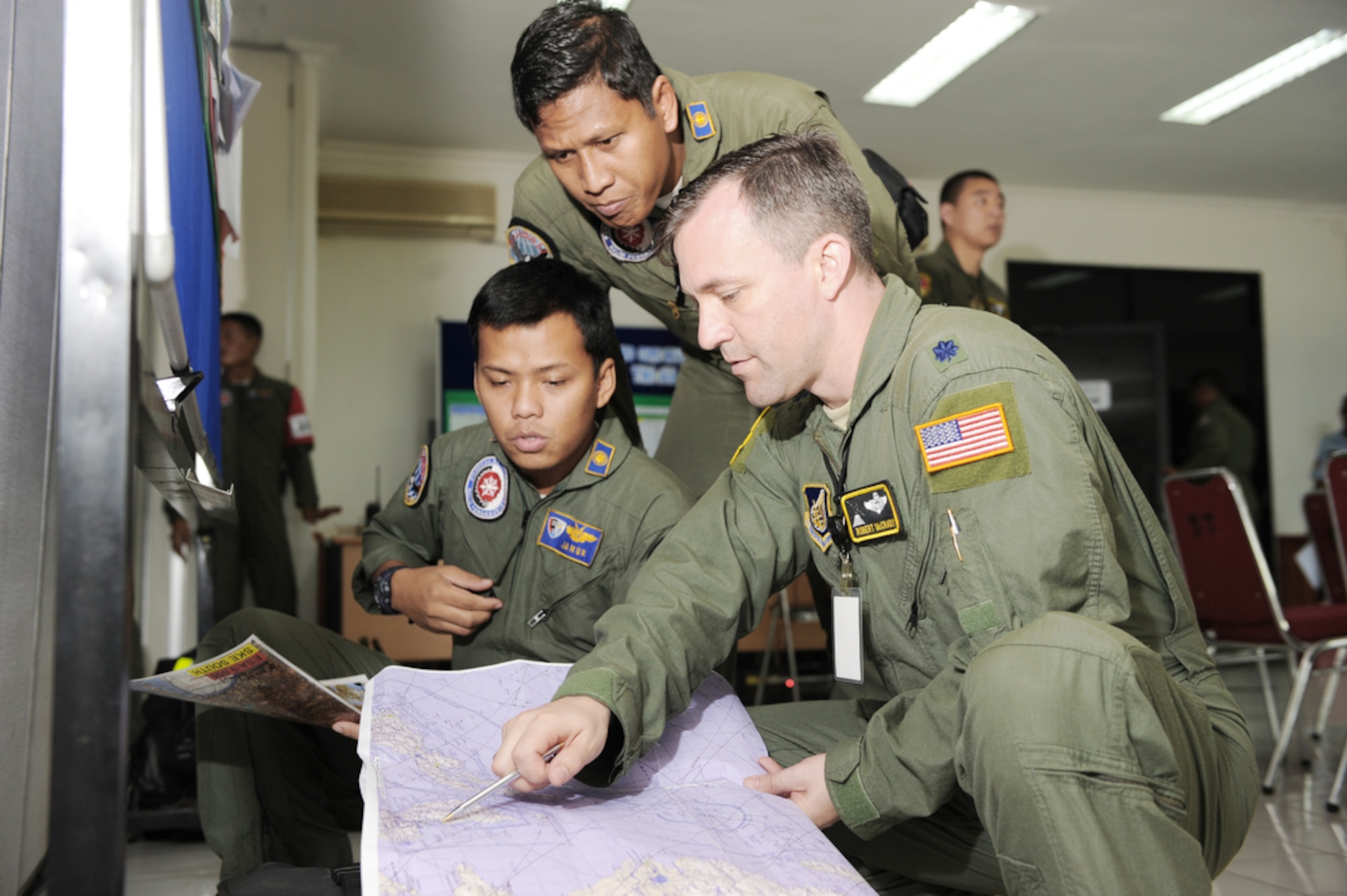 Lt. Col. Robert McCrady reviews a flight plan with Indonesian air force pilots after the completion of Exercise Cope West 10 April 23, 2010, at Halim Air Base, Indonesia. Cope West is a Pacific Air Forces-sponsored bilateral tactical airlift exercise involving the U.S. and Indonesian air forces. (U.S. Air Force photo/Tech. Sgt. Cohen A. Young)
