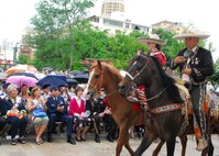 Brig. Gen. Leonard Patrick, 502nd Air Base Wing commander, and his wife Lynne view a procession of court subjects on their way to San Fernando Cathedral in downtown San Antonio during the public coronation of  El  Rey Feo LXII April 16. (U.S. Air Force photo by Alan Boedeker)