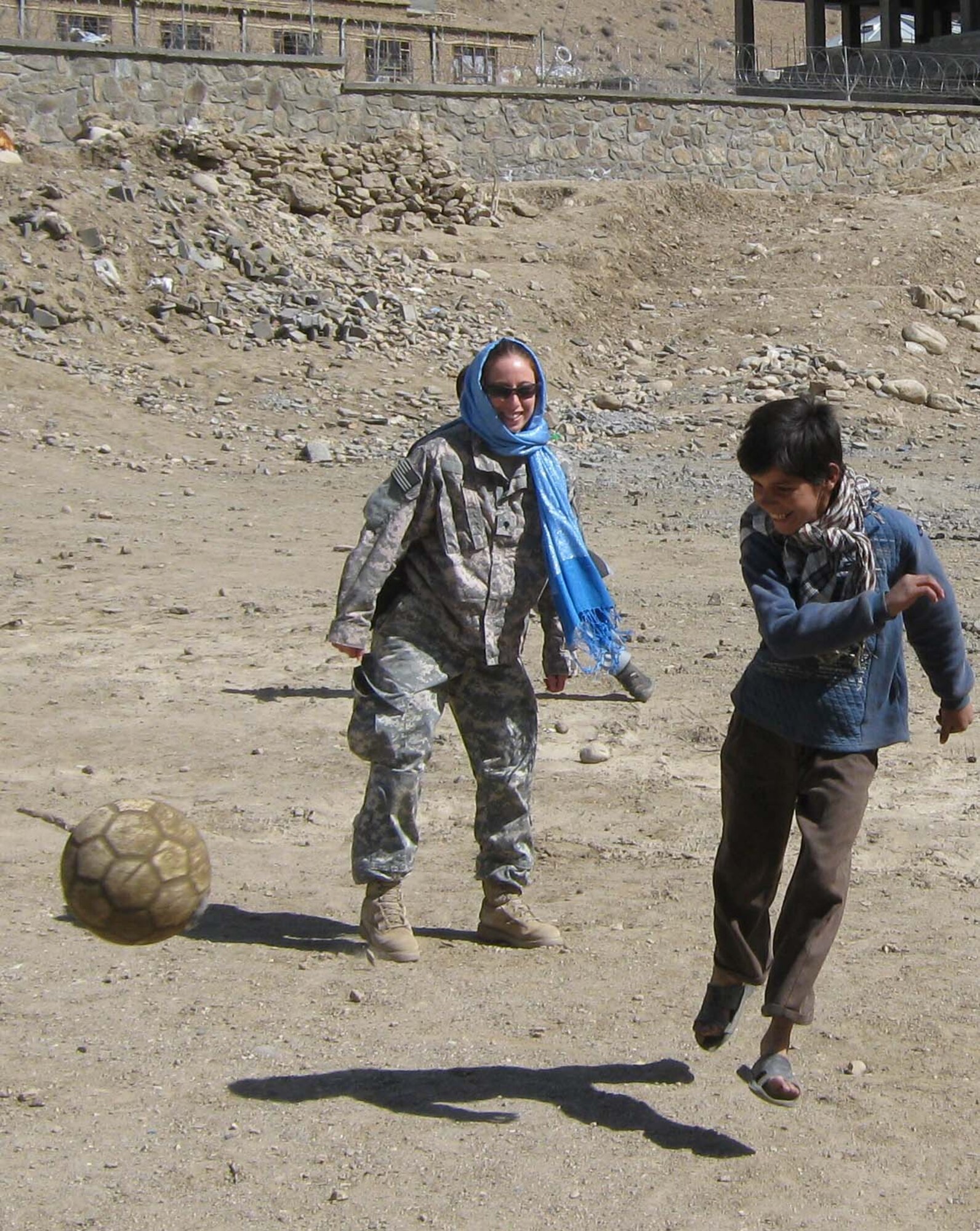Spc. Allison Cherkosly, Provincial Reconstruction Team Panjshir civil affairs, participates in a soccer match near the Khenj District Center March 27. Cherkosly and other members of PRT Panjshir joined in an impromptu game during an engineer mission to six different locations throughout the province. (Photo by U.S. Air Force 2nd Lt. Jason Smith, PRT Panjshir Public Affairs)