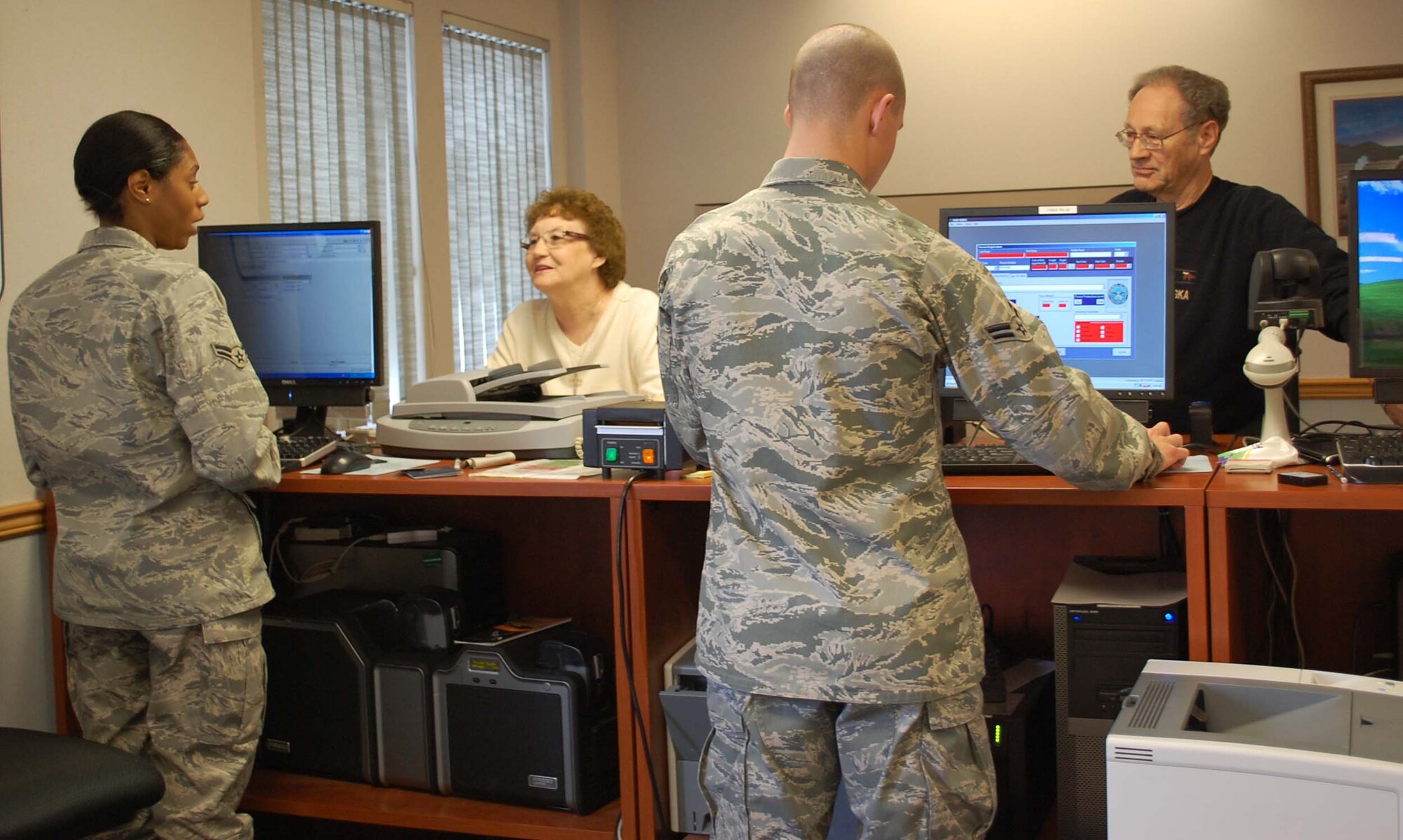 Airmen 1st Class Dynesha Adams and Mark Ashland, assist Lena and Stanley Cornell with getting new ID cards and registering for the Defense Biometric Identification System, or DBIDS, during their visit to Malmstrom April 24 for Retiree Appreciation Weekend. The Airmen are customer support journeymen with the 341st Force Support Squadron. (U.S. Air Force photo/Valerie Mullett)