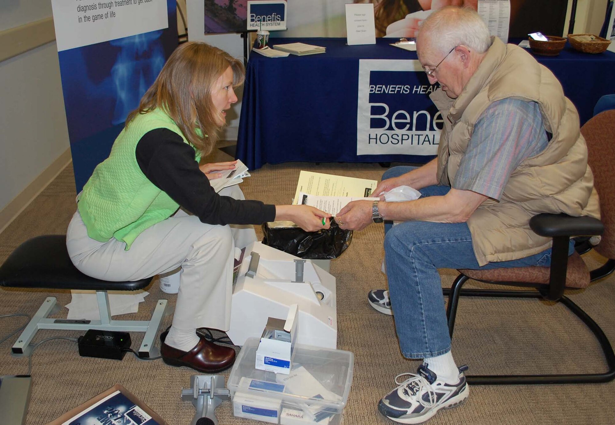 Amy Linder, a Benefis Healthcare employee, explains test result information to retiree Tom Geelan following a heel scan April 24 at the Malmstrom Clinic. The osteoporosis test was one of many services offered to retirees visiting Malmstrom for the annual Retiree's Appreciation Weekend April 23-25. (U.S. Air Force photo/Valerie Mullett)