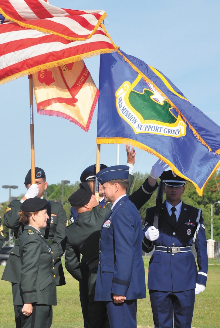 The 502nd Mission Support Group flag unfurls behind Col. Mary Garr, 502 MSG/Garrison commander and Air Force Brig. Gen. Leonard Patrick, commander of the 502nd Air Base Wing, after the group’s official activation at Fort Sam Houston’s MacArthur Parade Field April 26.