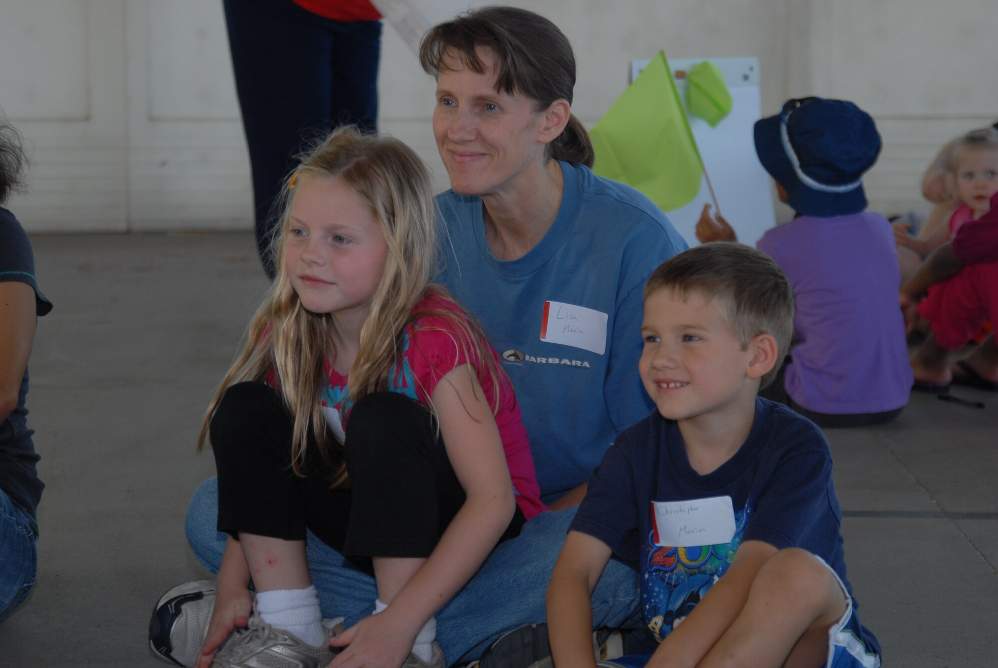 Lt. Col. Lisa Manion, 623rd Air and Space Operations Center, and her children Alexandra and Christopher sit in a discussion group about the book "Mercedes and the Chocolate Pilot" during the Military Child Education Coalition's "Tell Me a Story" program hosted by the Airman & Family Readiness Center's School Liaison Program at Hurlburt Field, April 25. The book reading was scheduled as part of the base's events for the Month of the Military Child. (DoD photo by U. S. Air Force Staff Sgt. Orly N. Tyrell/Released)