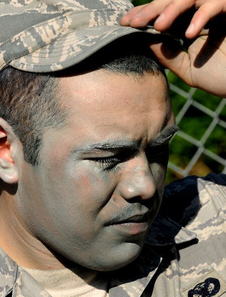 MOODY AIR FORCE BASE, Ga. -- Senior Airman Krystoffer Miller, 822nd Security Forces Squadron fire team leader, wipes the sweat from his forehead after completing the entry control point portion of the validation exercise here April 27. The validation exercise tested the warrior skills of the members from the 822nd SFS by forcing them to react during real-world scenarios. (U.S. Air Force photo by Airman 1st Class Benjamin Wiseman/RELEASED)