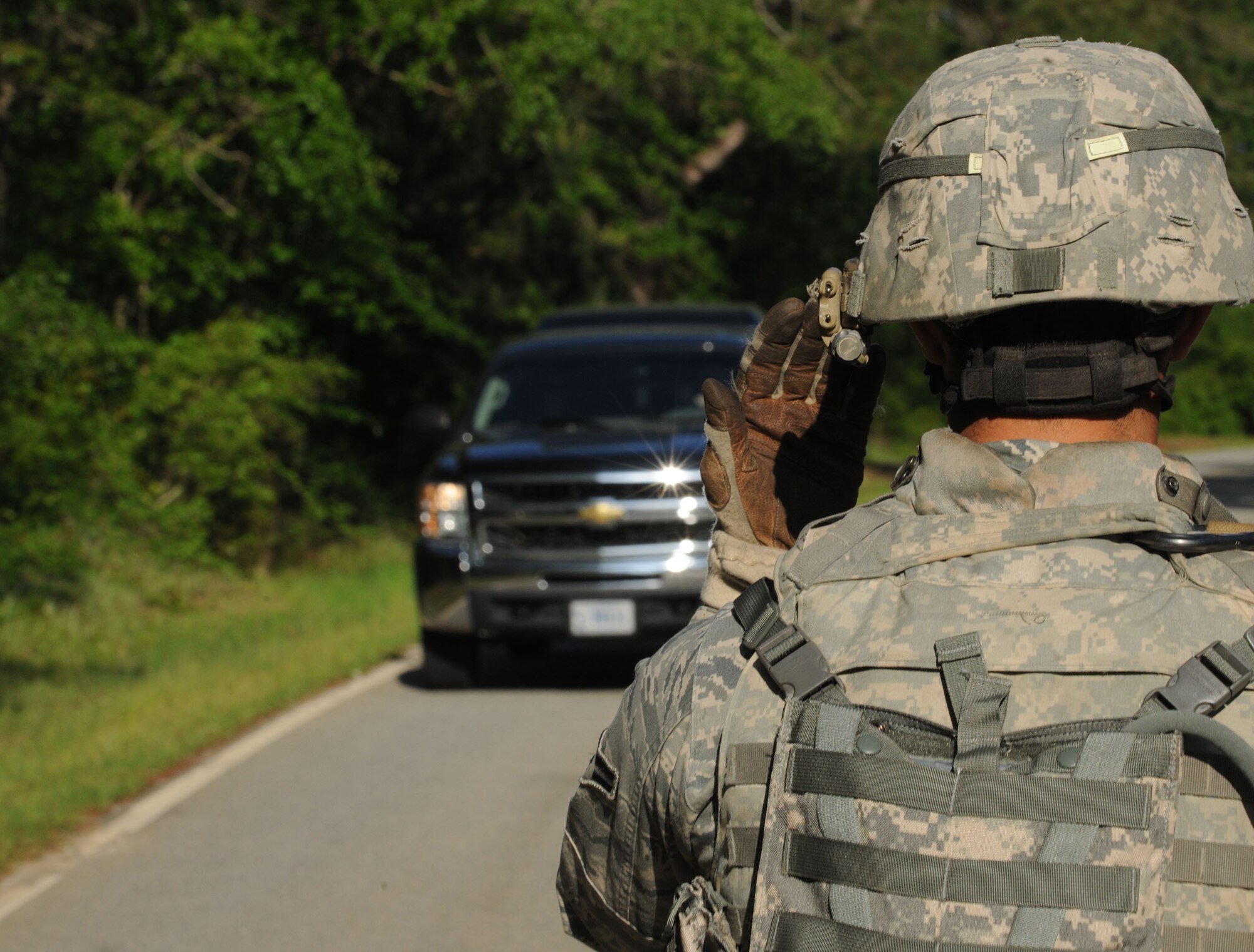 MOODY AIR FORCE BASE, Ga. -- Airman 1st Class Dylan Vankerckhoven, 822nd Security Forces Squadron fire team member, motions a vehicle to move through the check point during a validation exercise here April 27. The 822nd SFS practiced searching vehicles and checking identification cards at a set up entry control point. (U.S. Air Force photo by Airman 1st Class Benjamin Wiseman/RELEASED)