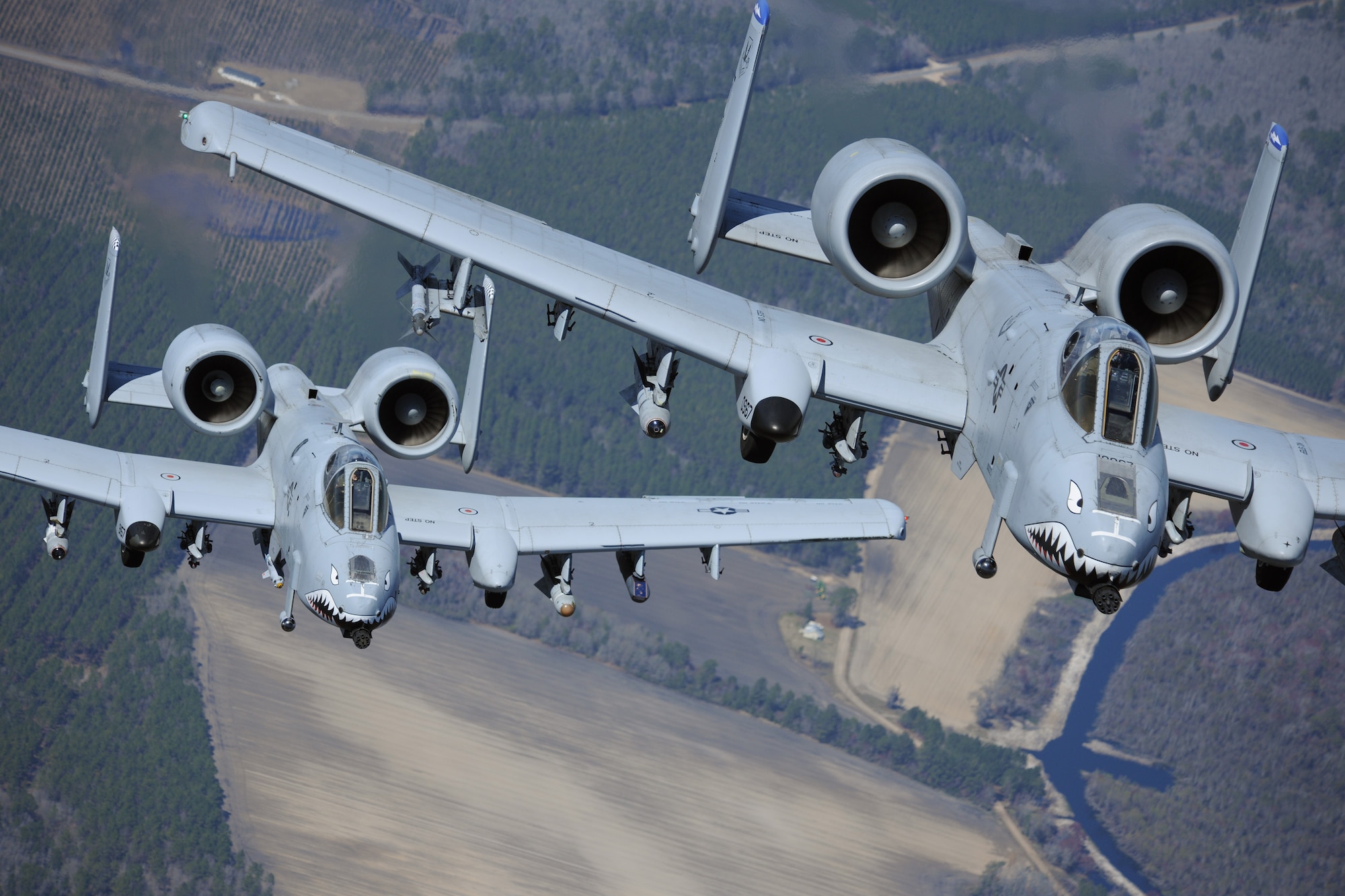 MOODY AIR FORCE BASE, Ga. -- Two A-10C Thunderbolt II aircraft fly in formation during a training exercise here March 16. The 74th Fighter Squadron performed surge operations to push its support function to the limit and simulate pilots’ war-time flying rates. (U.S. Air Force photo by Airman 1st Class Benjamin Wiseman/RELEASED)