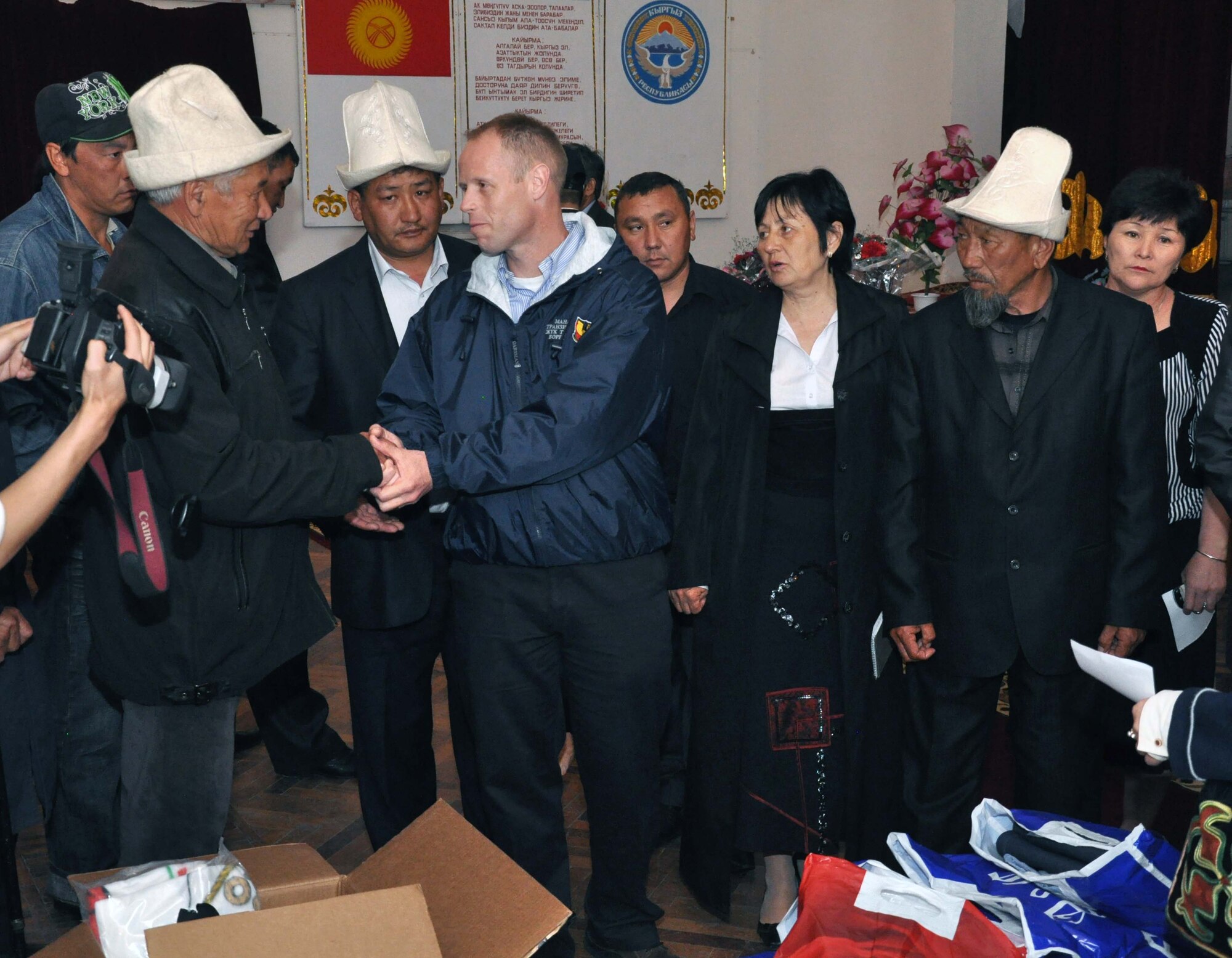 Col. Blaine Holt, director of the Transit Center at Manas, Kyrgyzstan, speaks to the father of one of five men in who, among many, were slain during the recent unrest in Kyrgyzstan.  U.S. Airmen from the Transit Center at Manas attended the ceremony in TokMok April 29, 2010, to honor them, and donated dry and household goods to assist their surviving family members. (U.S. Air Force photo/Staff Sgt. Carolyn Viss)