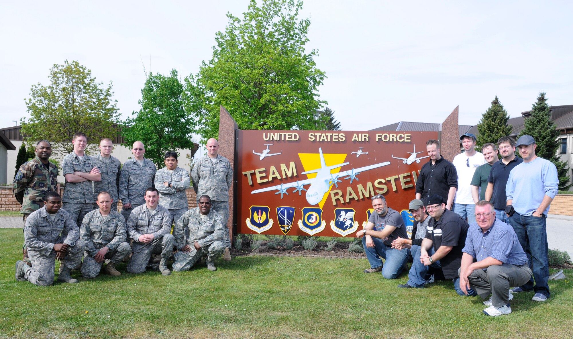 Professional cartoonist from the National Cartoonist Society take a photo with their U.S. Air Force escorts, Ramstein Air Base, Germany, April 29, 2010. While at Ramstein, Airmen escorted the cartoonist around visiting various locations like the flight tower, flightline, fire department, C-130 J Super Hercules, C-17 aircraft and the 435th Contingency Response Group. (U.S. Air Force photo by Airman 1st Class Brittany Perry)