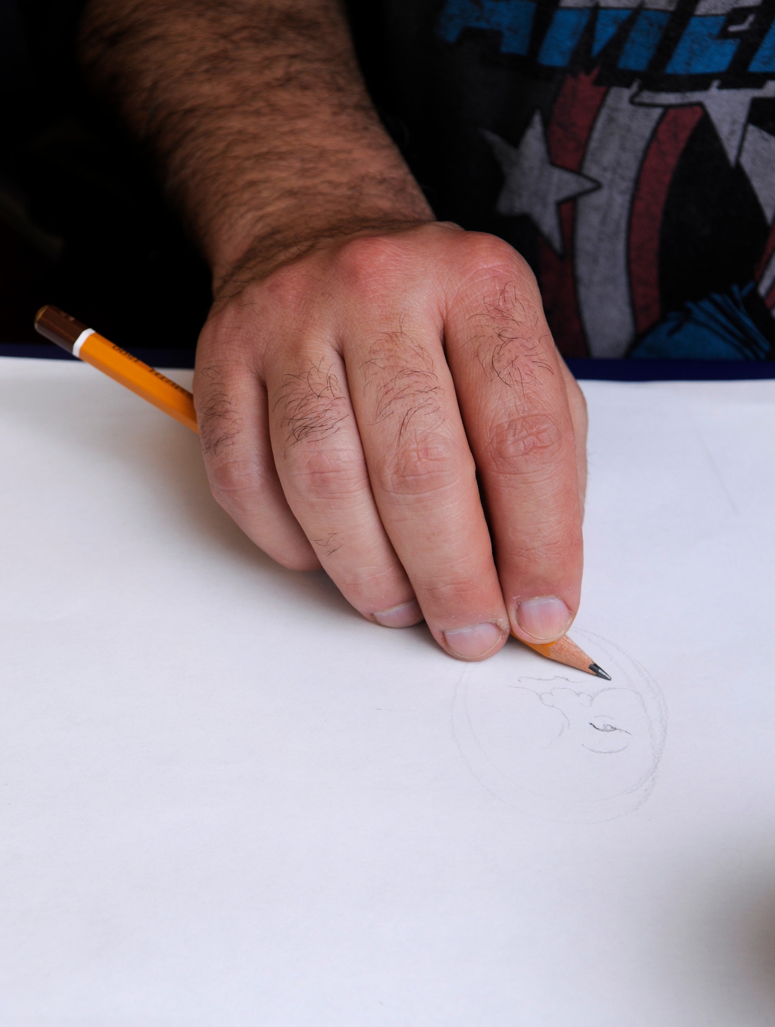 Ray Alma, MAD magazine artist, sketches a caricature, Ramstein Air Base, Germany, April 29, 2010. Mr. Alma is one of 9 professional cartoonist from the National Cartoonist Society that visited various areas on Ramstein as part of a morale tour in cooperation with the United Service Organizations. (U.S. Air Force photo by Airman 1st Class Brittany Perry)