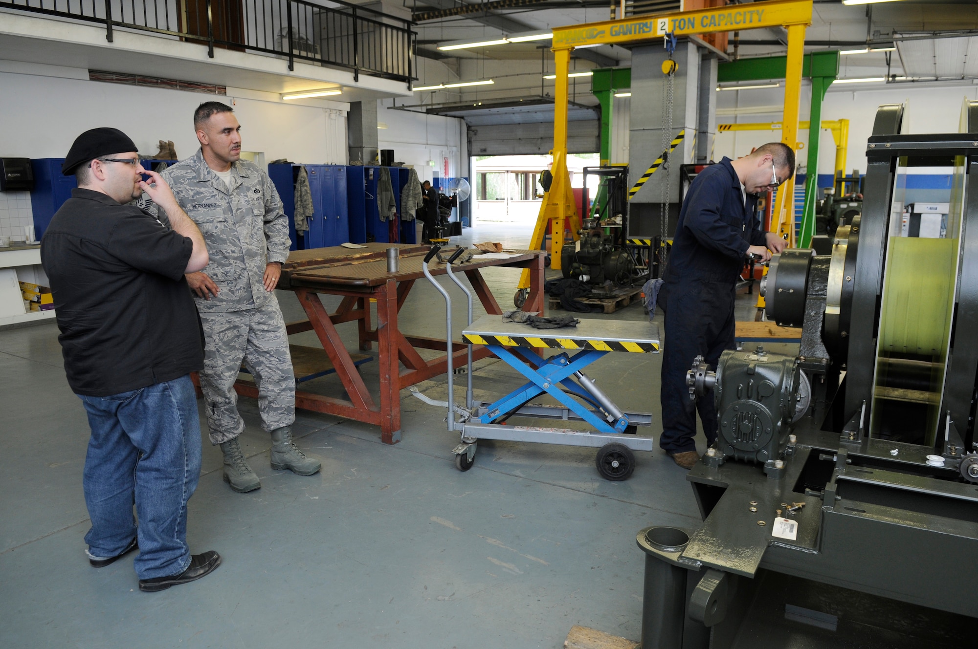 Mason Mastroianni, artist of B.C. comic strip, receives information on a Mobile Aircraft Arresting System from U.S. Air Force Master Sgt. Francisco Hernandez, 435th Contruction Training Squadron, superintendent, command aircraft arresting system depot operations, Ramstein Air Base, Germany, April 29, 2010. Mr. Mastronianni is one of 9 professional cartoonist from the National Cartoonist Society that visited various areas on Ramstein as part of a morale tour in cooperation with the United Service Organizations. (U.S. Air Force photo by Airman 1st Class Brittany Perry)