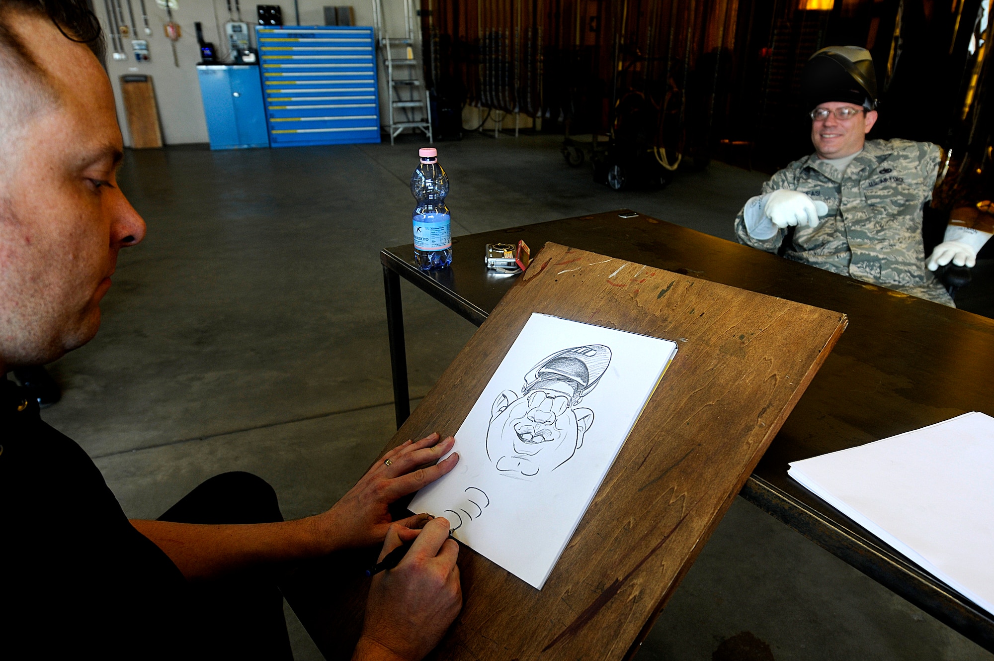 Mr. Ed Steckley, MAD magazine artist for DC comics, sketches U.S. Air Force Tech. Sgt. Jim Gifasi, 86th Maintenance Squadron aircraft metal technician, Ramstein Air Base, Germany, April 29, 2010. Several cartoonists took part in a two-day tour of the Kaiserslautern Military Community, visiting with wounded warriors, military members and their families. (U.S. Air Force photo by Airman 1st Class Brea Miller)