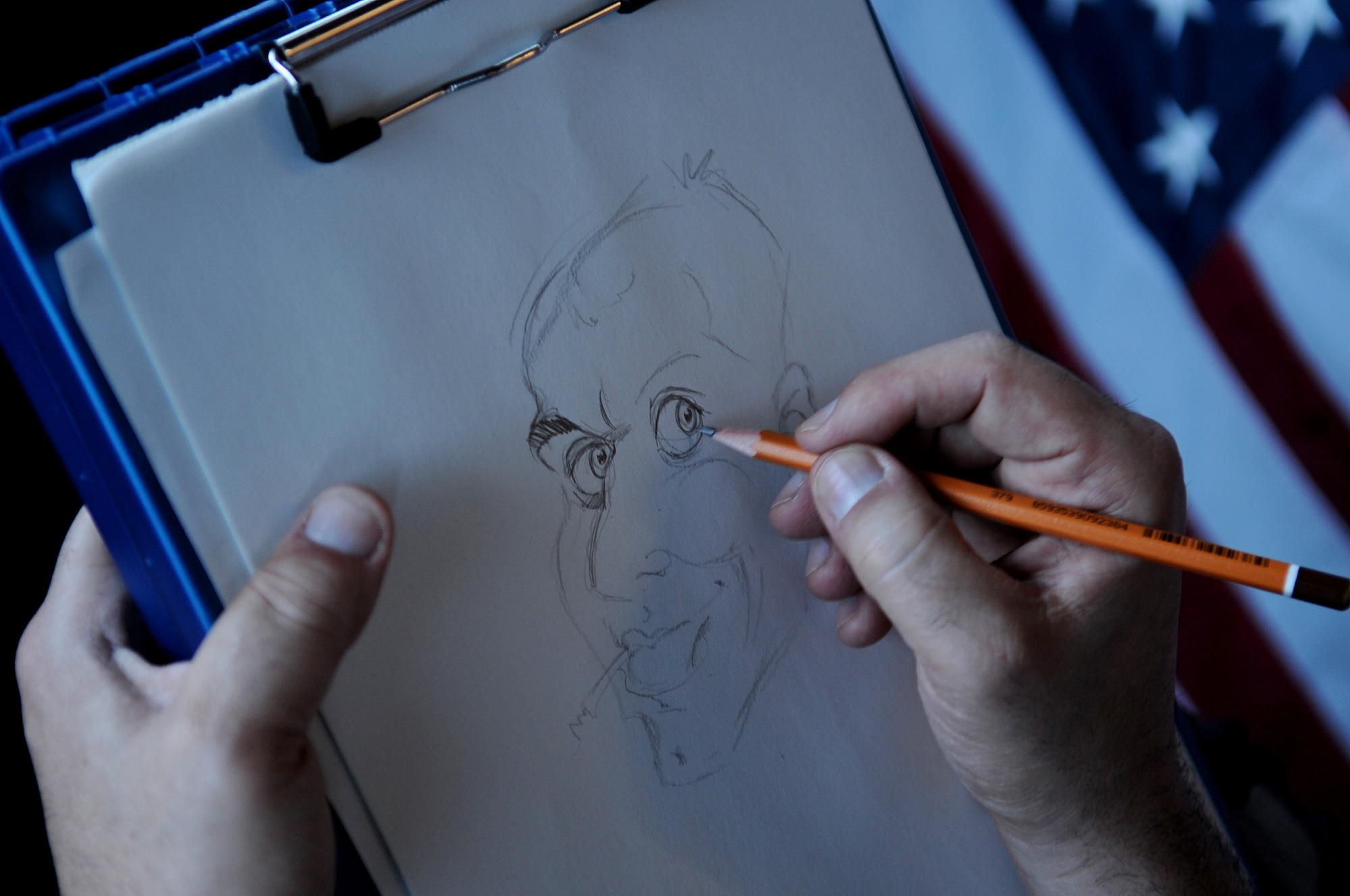 Ray Alma, Mad Magazine cartoonist, draws a protrait of an Airman during a United Service Organizations tour, Ramstein Air Base, Germany, April 29, 2010. Ray started drawing while in elementary school and does freelance drawings in New York City, N.Y. (U.S. Air Force photo by Airman 1st Class Grovert Fuentes-Contreras)