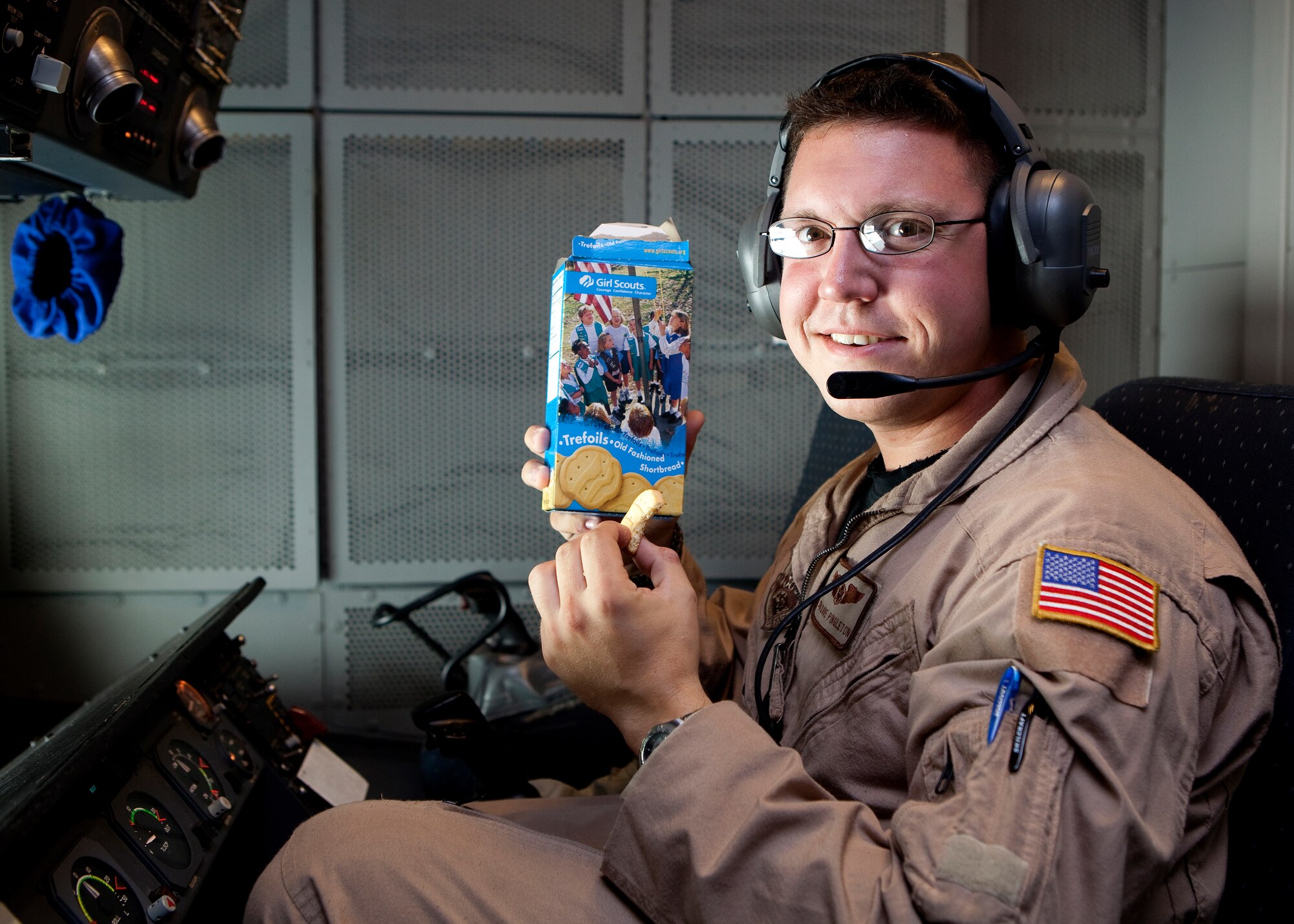 Recently the hearts of deployed 380th Air Expeditionary Wing Airmen at an undisclosed location in Southwest Asia were warmed when they received a sweet gesture from California Girl Scouts in the form of 1,800 boxes of Girl Scout Cookies. Junior Troop #361 in Vacaville, Calif. sent the cookies which have made their way all over base. This Airman from the 908th Expeditionary Air Refueling Squadron poses with his favorite, Trefoils, on the flight deck of KC-10 Extender aircraft where he serves as an aircrew member. (U.S. Air Force photo/Staff Sgt. Leonel Gallardo/released)