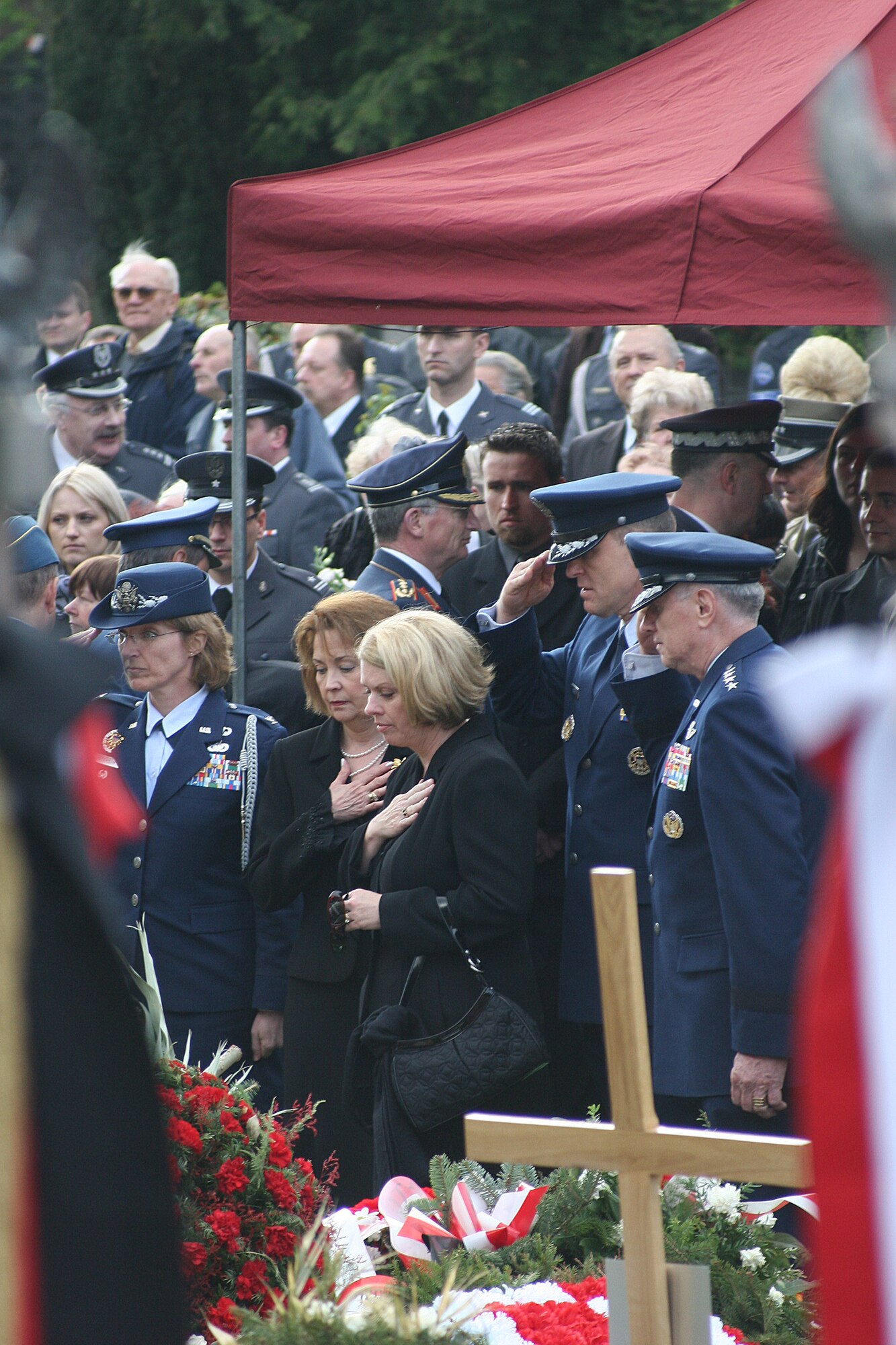 WARSAW, Poland -- Col. Mary Peterson, U.S. Air Attaché to Poland; Litha Brady; Sharon Gorenc; Lt. Gen. Frank Gorenc, 3rd Air Force commander; and Gen. Roger Brady, U.S. Air Forces in Europe and NATO Allied Air Command Ramstein commander, pay final respects to Polish air force commander Gen. Andrzej Blasik April 28, 2010, following funeral services in Warsaw’s Powazki cemetery. General Blasik died April 10 alongside Polish president Lech Kaczynski and many other top Polish military leaders when the Polish air force Tu-154 plane he was on crashed in a forest outside the military airport in Smolensk, Russia, en route to commemorate the 70th anniversary of the Katyn massacre by the Soviet Union’s secret police. (U.S. Air Force photos/Lt. Col. Pamela A.Q. Cook)
