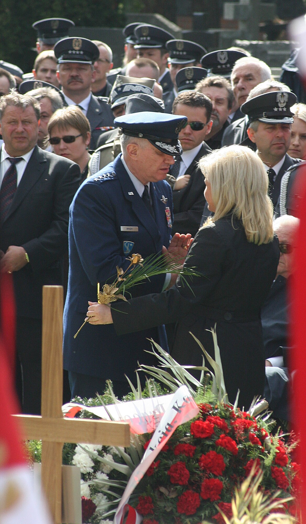 WARSAW, Poland -- Gen. Roger Brady, U.S. Air Forces in Europe and NATO Allied Air Command Ramstein commander, consoles Ewa Blasik after making remarks during funeral services for her husband, Polish air force commander Gen. Andrzej Blasik, April 28, 2010, in Warsaw’s Powazki cemetery. General Blasik died April 10 alongside Polish president Lech Kaczynski and many other top Polish military leaders when the Polish air force Tu-154 plane he was on crashed in a forest outside the military airport in Smolensk, Russia, en route to commemorate the 70th anniversary of the Katyn massacre by the Soviet Union’s secret police. (U.S. Air Force photos/Lt. Col. Pamela A.Q. Cook)