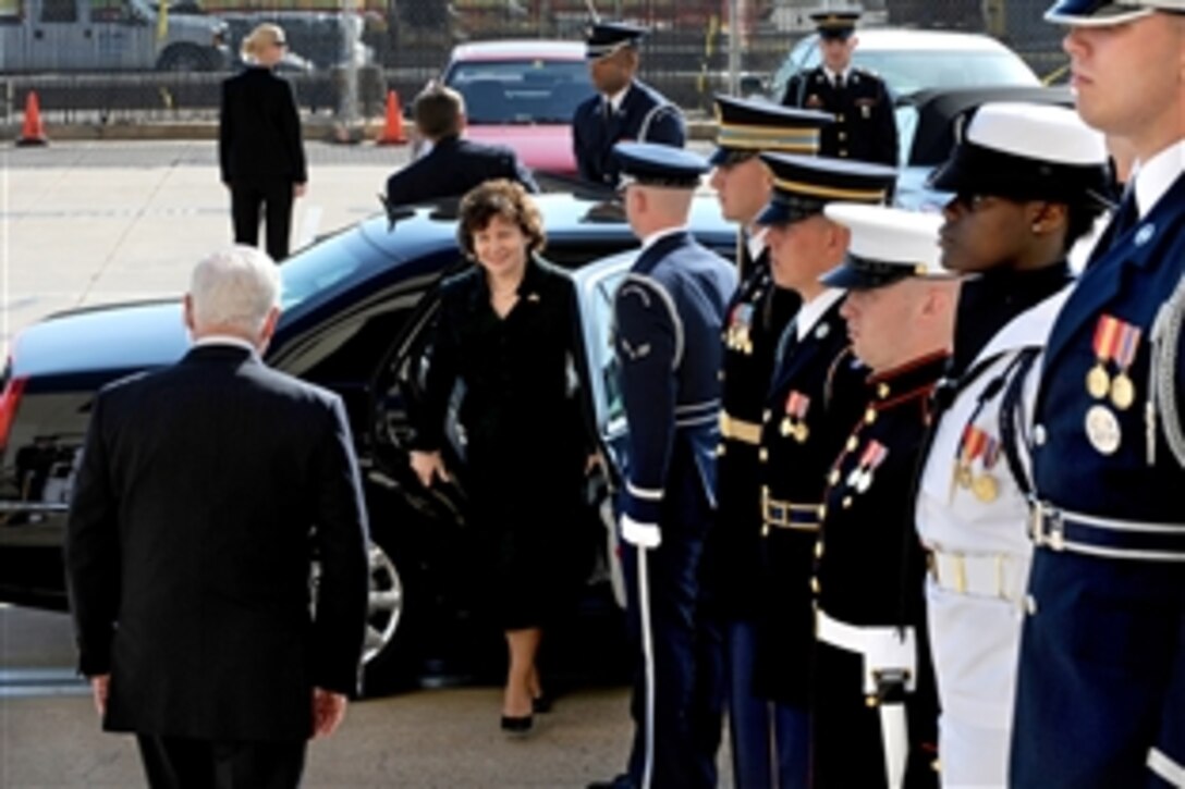 Defense Secretary Robert M. Gates is on hand to welcome Lithuanian Minister of National Defense Rasa Jukneviciene as she steps from her limousine at the Pentagon River Entrance on April 30, 2010. The two defense leaders were slated to hold security talks on a variety of issues of mutual interest to both nations.  