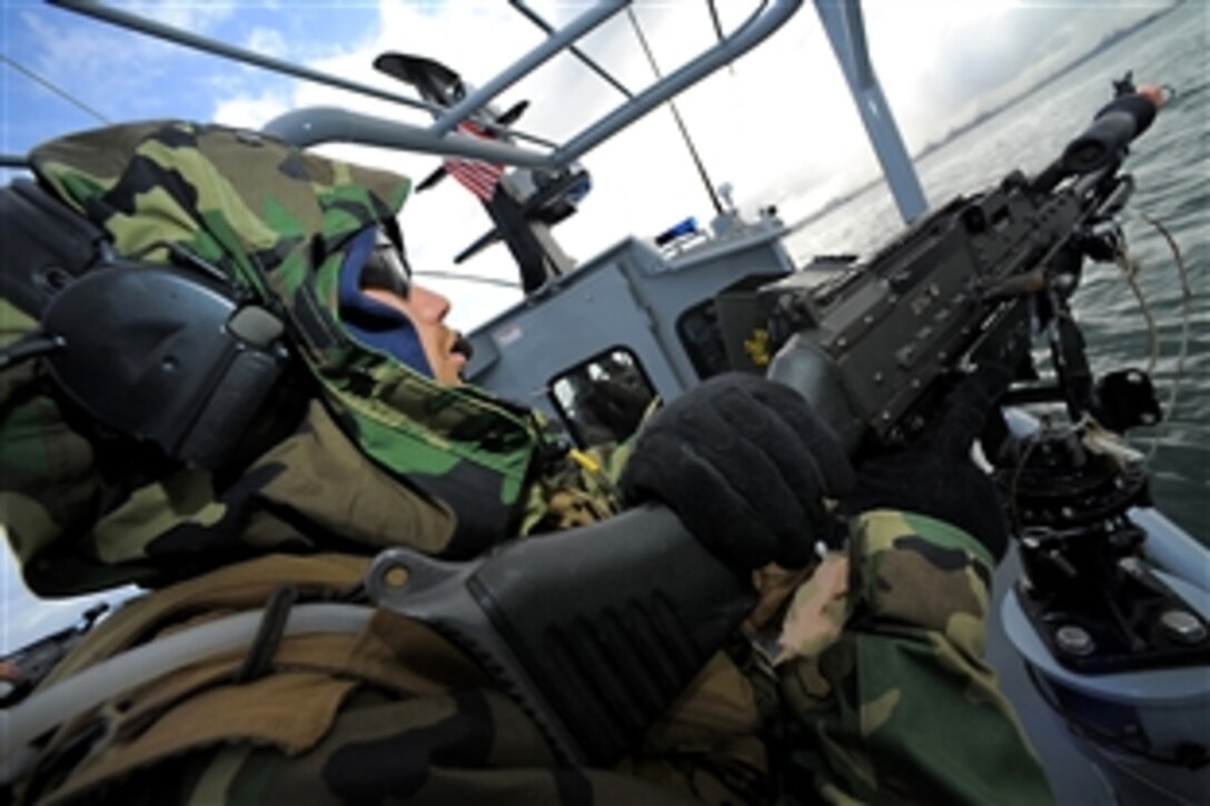 U.S. Navy Petty Officer 3rd Class Harry Crawford mans an M-240B machine gun aboard a rigid-hull inflatable boat during a Navy Expeditionary Combat Command Integrated Exercise in San Diego, April 22, 2010. The weeklong training exercise is designed to provide realistic combat training in preparation for upcoming deployments.