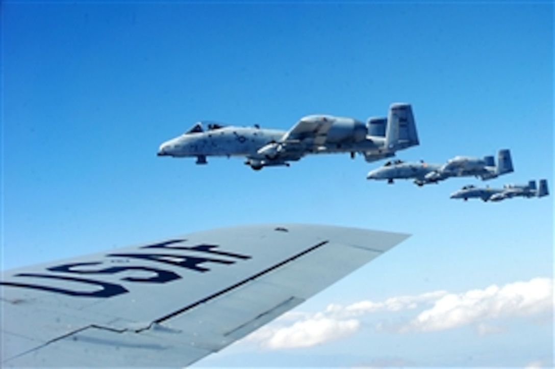 Three A-10C Thunderbolt IIs fly in formation beside a KC-135 Stratotanker, April 27, 2010, during an aerial refueling mission over Southern Arizona. The A-10 pilots are assigned to the 358th Fighter Squadron at Davis-Monthan Air Force Base, Ariz.