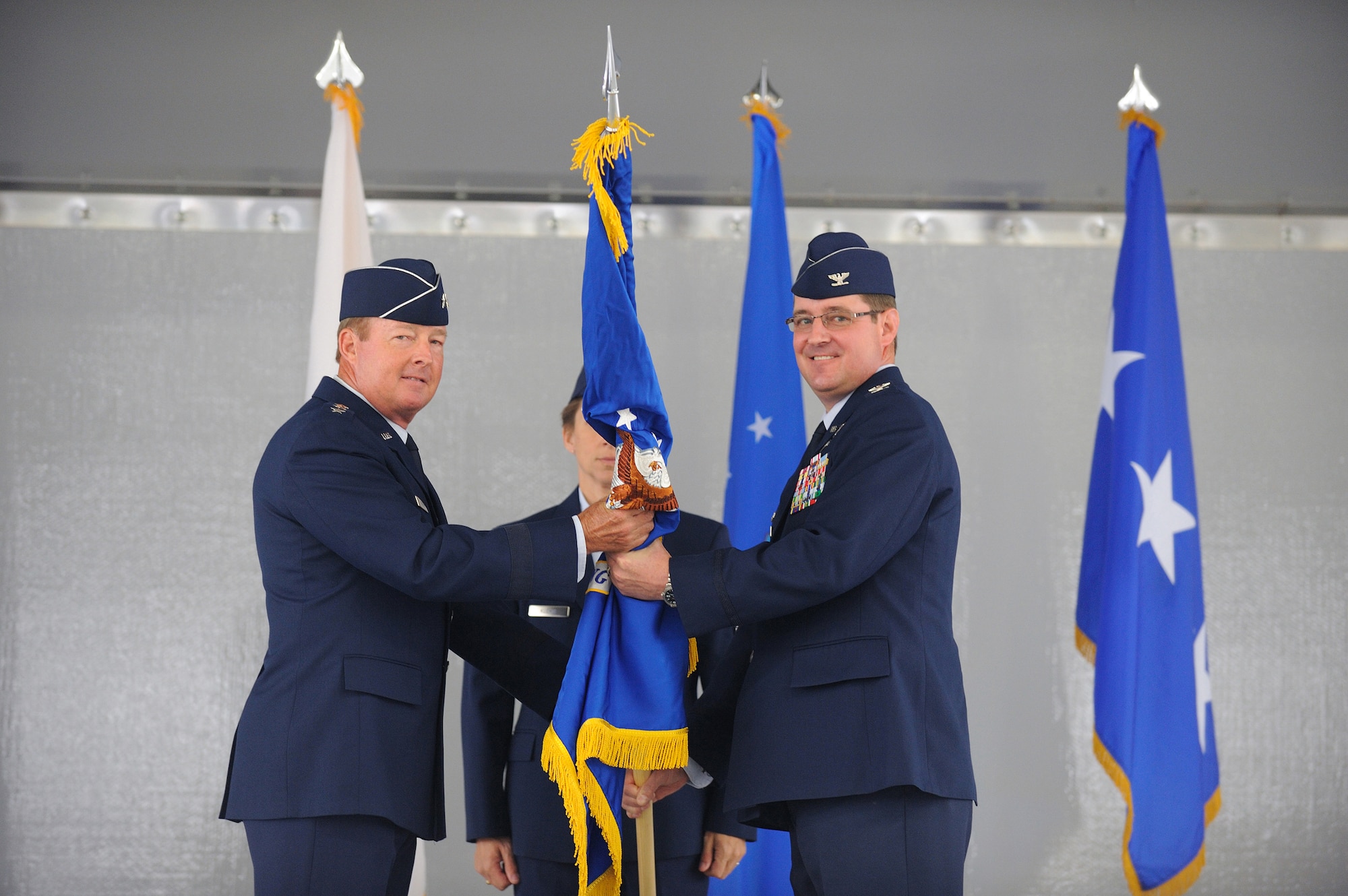 JOINT BASE ELMENDORF-RICHARDSON, Alaska -- Lt. Gen. Dana T. Atkins, commander Alaska Command, passes the 673d Air Base Wing (673d ABW) guidon to Col. Robert D. Evans, commander 673d Air Base Wing, during the unit's activation ceremony July 30. The 673d ABW is the supporting unit for Joint Base Elmendorf-Richardson which is comprised of over 6,000 military, civilian and contractors from both Elmendorf Air Force Base and Fort Richardson Army Garrison near Anchorage, Alaska. (Air Force photo by Master Sgt. Jeremiah Erickson)