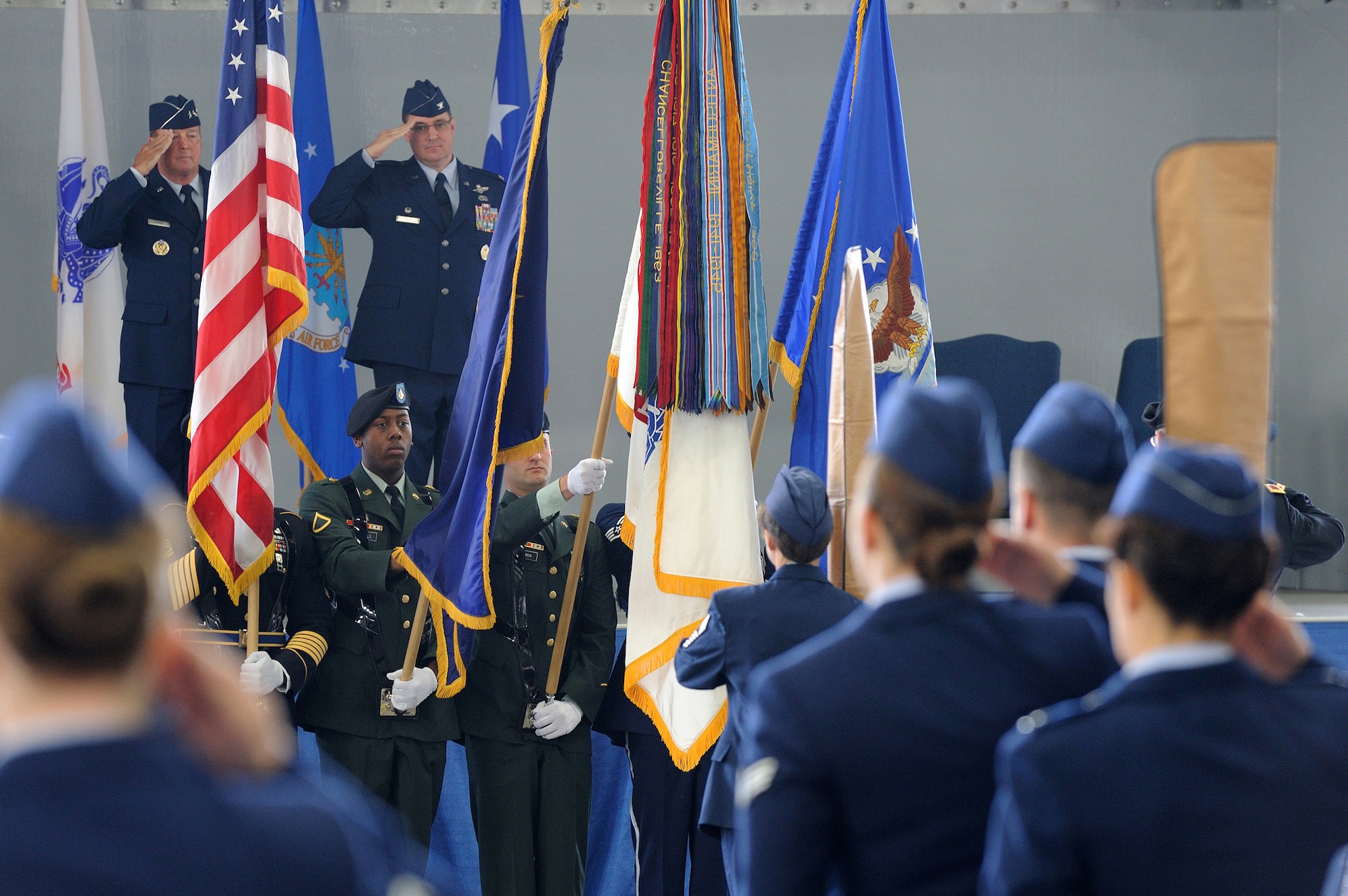 U. S. Air Force Lt .Gen. Dana Atkins, Alaskan Command commander and Air Force Col. Robert Evans, Joint Base Elmendorf-Richardson/673d Air Base Wing commander, pay respect to the colors presented by a joint color guard during the 673d ABW's July 30, 2010 activation ceremony, and Joint Base Elemendorf-Richardson, Alaska. (U.S. Air Force photo/Master Sgt. Jeremiah Erickson)