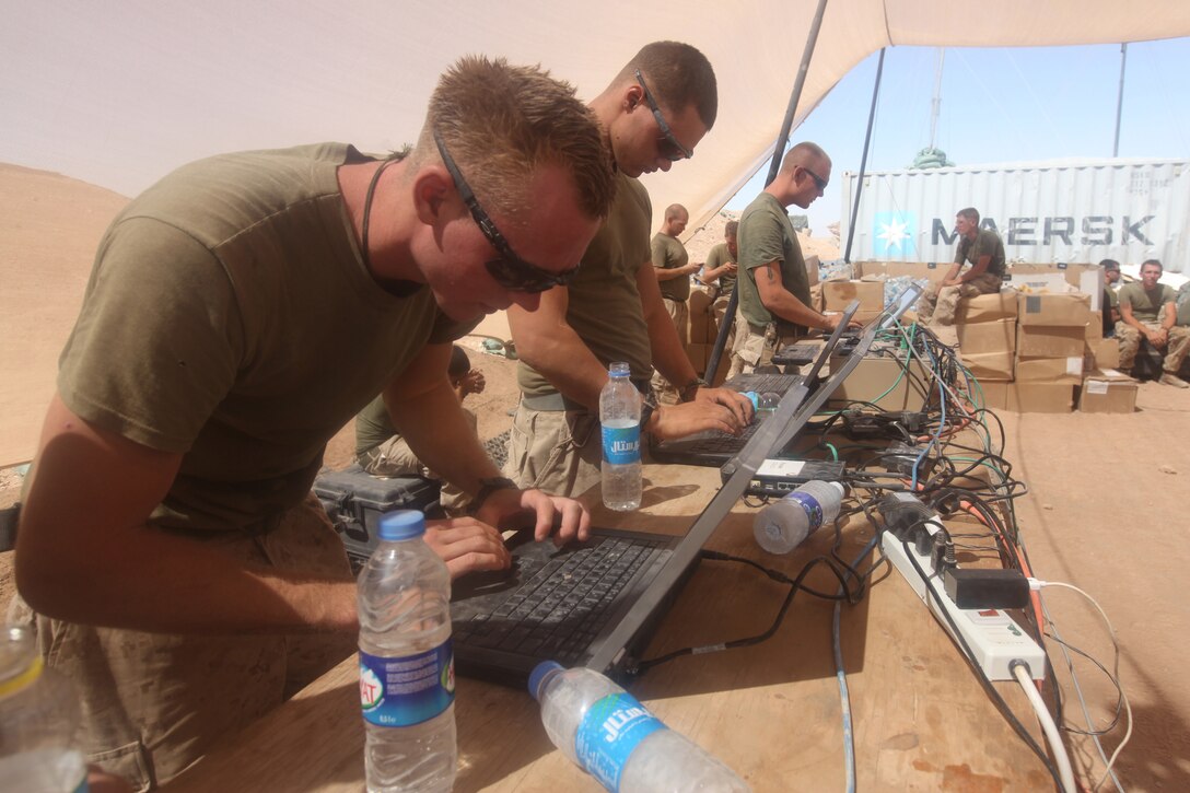 Marines with 1st Battalion, 2nd Marine Regiment, log on to social networking web sites to reconnect with friends and family as part of a Warrior Express Services Team mission in northern Helmand Province, July 16-30. These Marines were excited to see the Morale Satellite get set up for them to use the Internet, which is a rare luxury for Marines serving at remote forward operating bases.